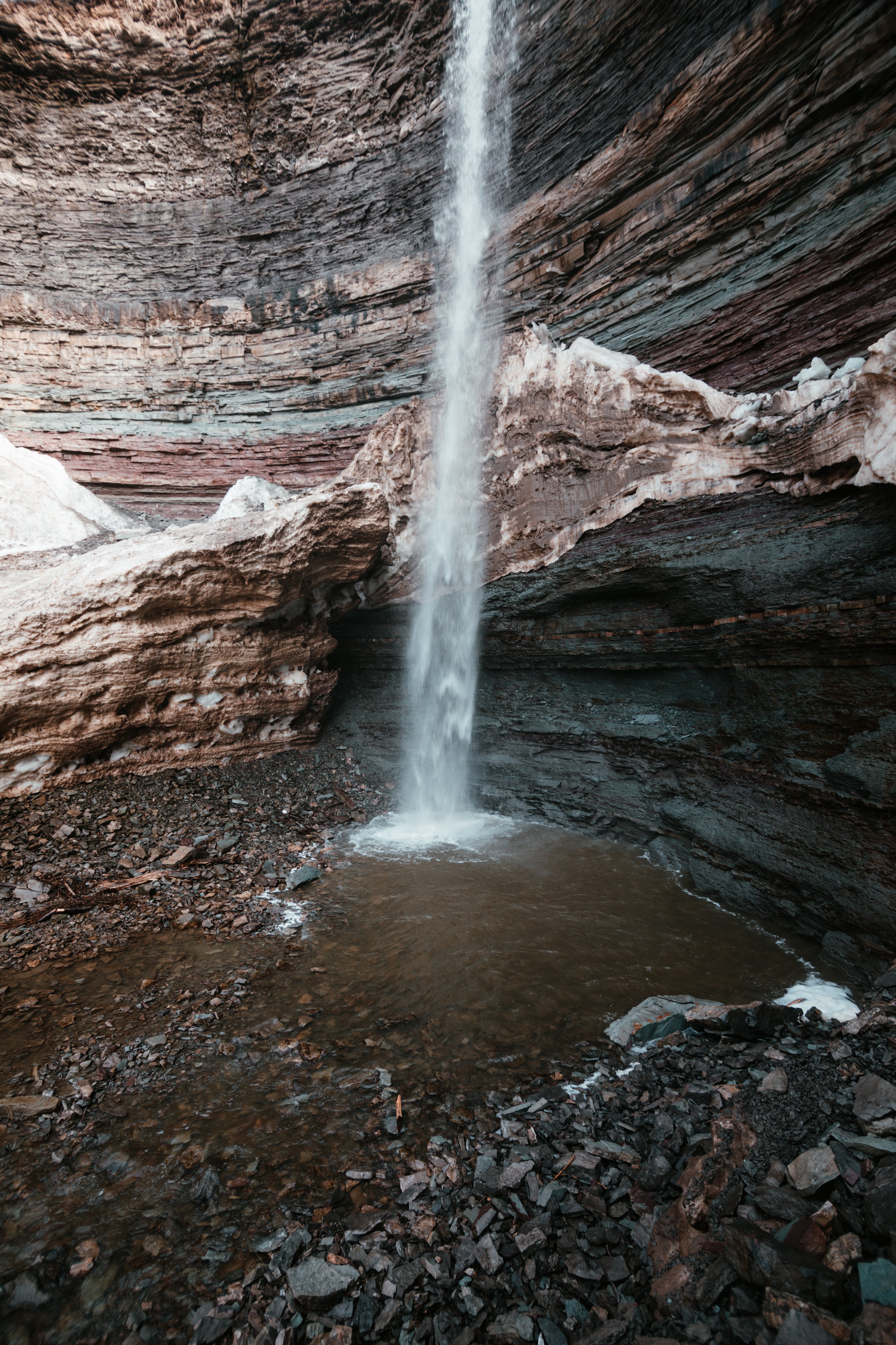 Stunning Waterfall Cascading in a Dramatic Rocky Cavern – Breathtaking Photo