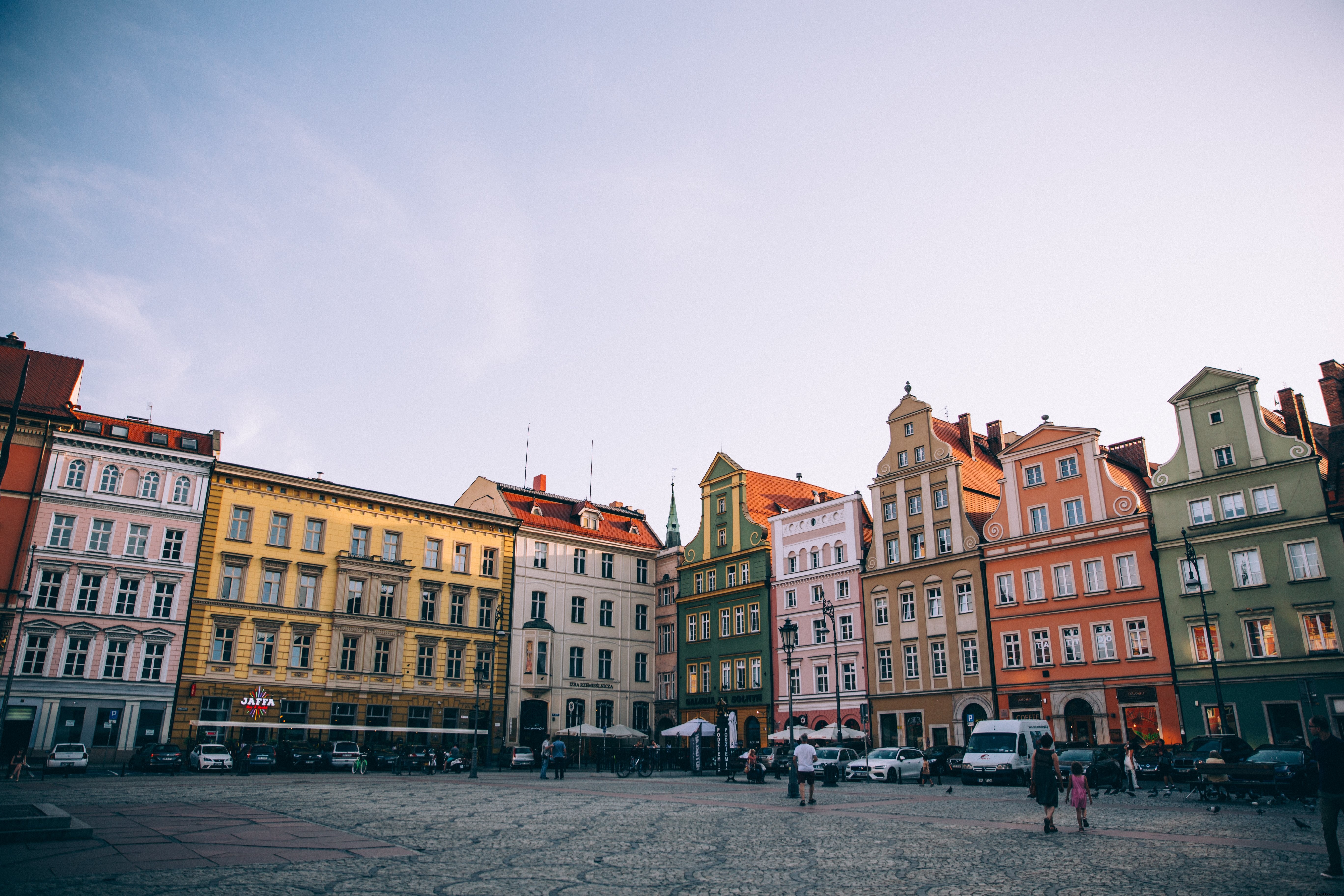 Stunning Sunset Over a Vibrant European Town Square with Colorful Buildings