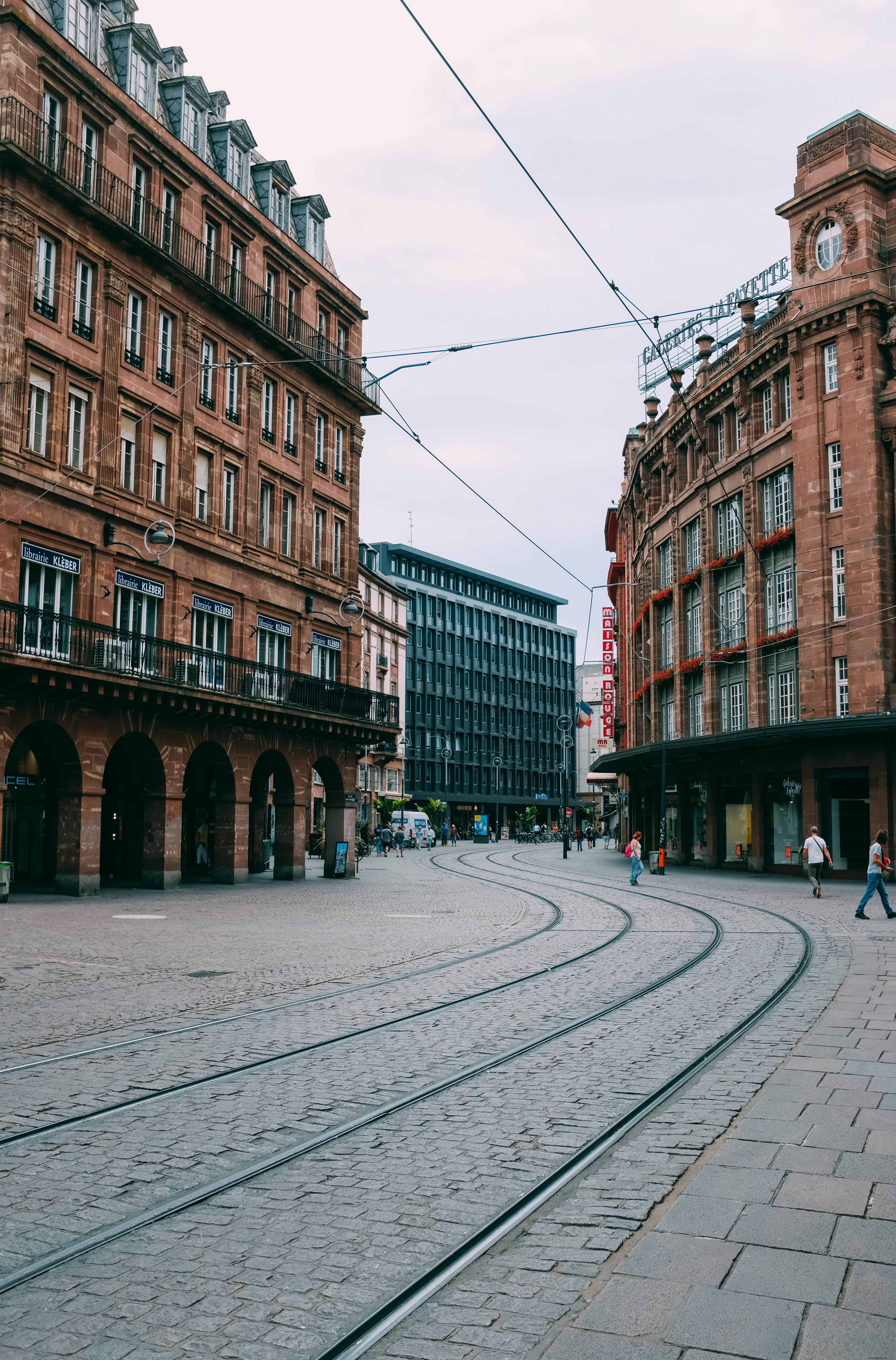 Stunning Photo: Red Brick Buildings and Tram Lines on Historic Cobblestone Streets