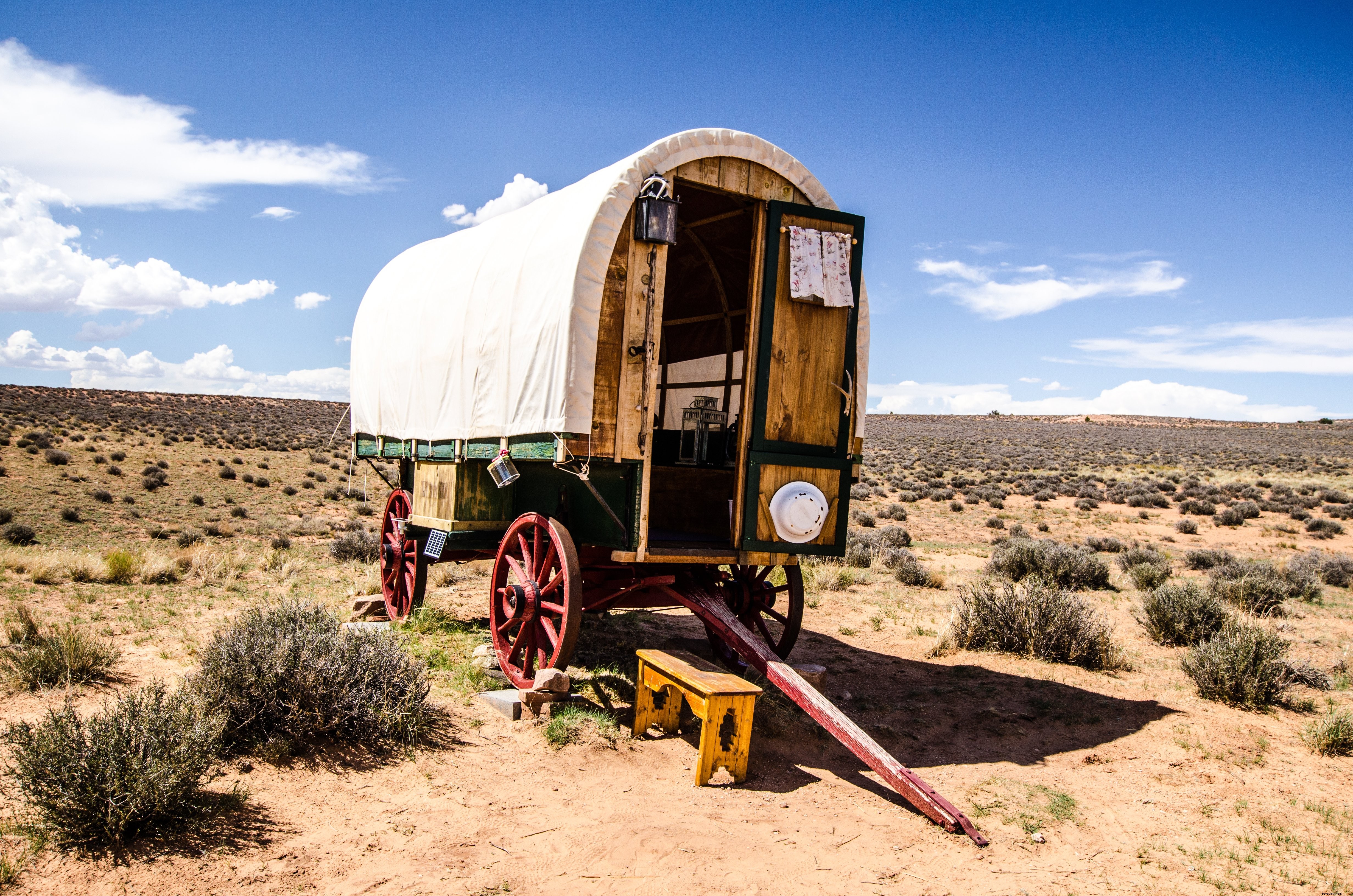 Stunning Photo: Traditional Caravan Resting on Vast Plains Under Clear Blue Skies