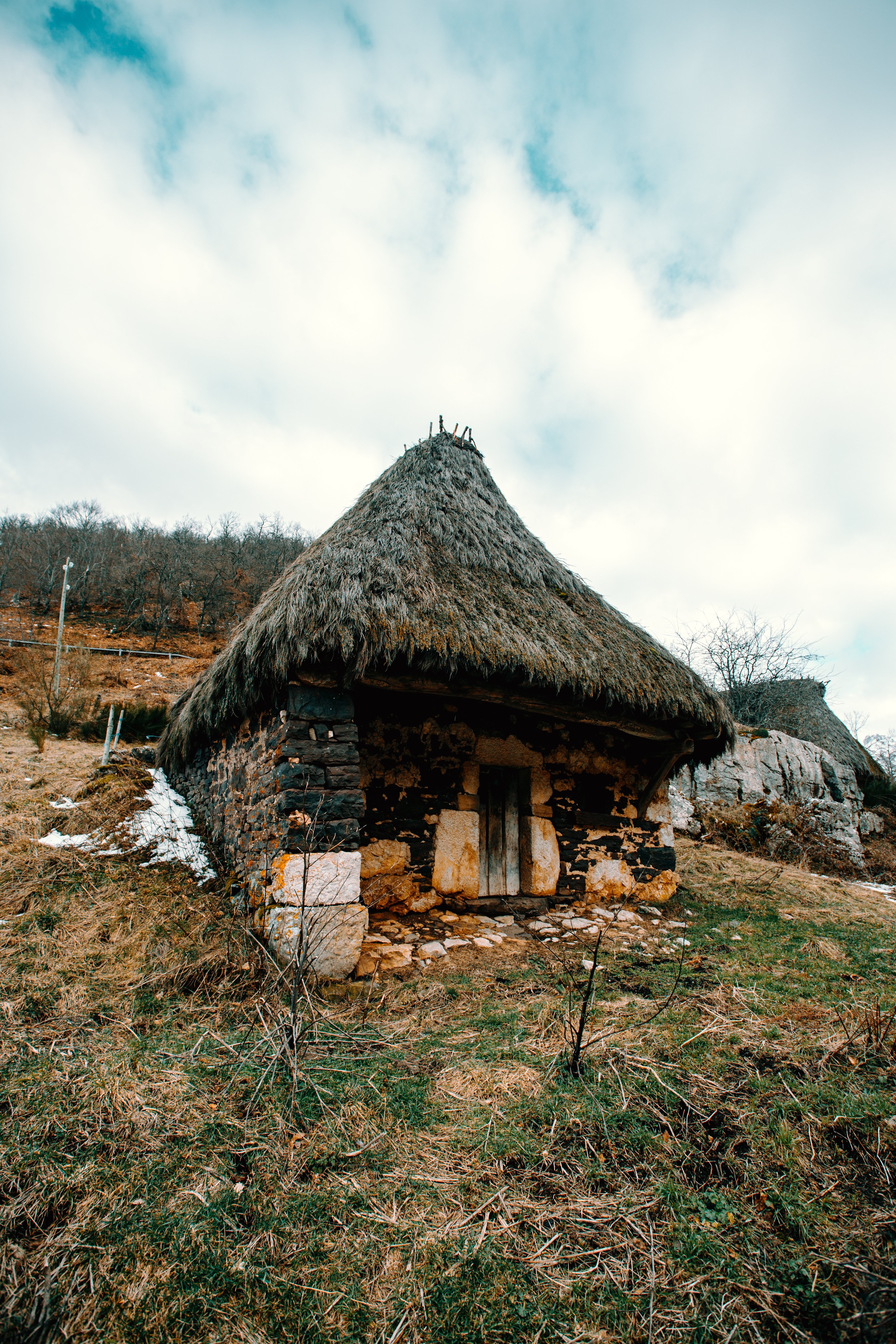 Picturesque Stone Hut Perched on a Hillside: Stunning Landscape Photo