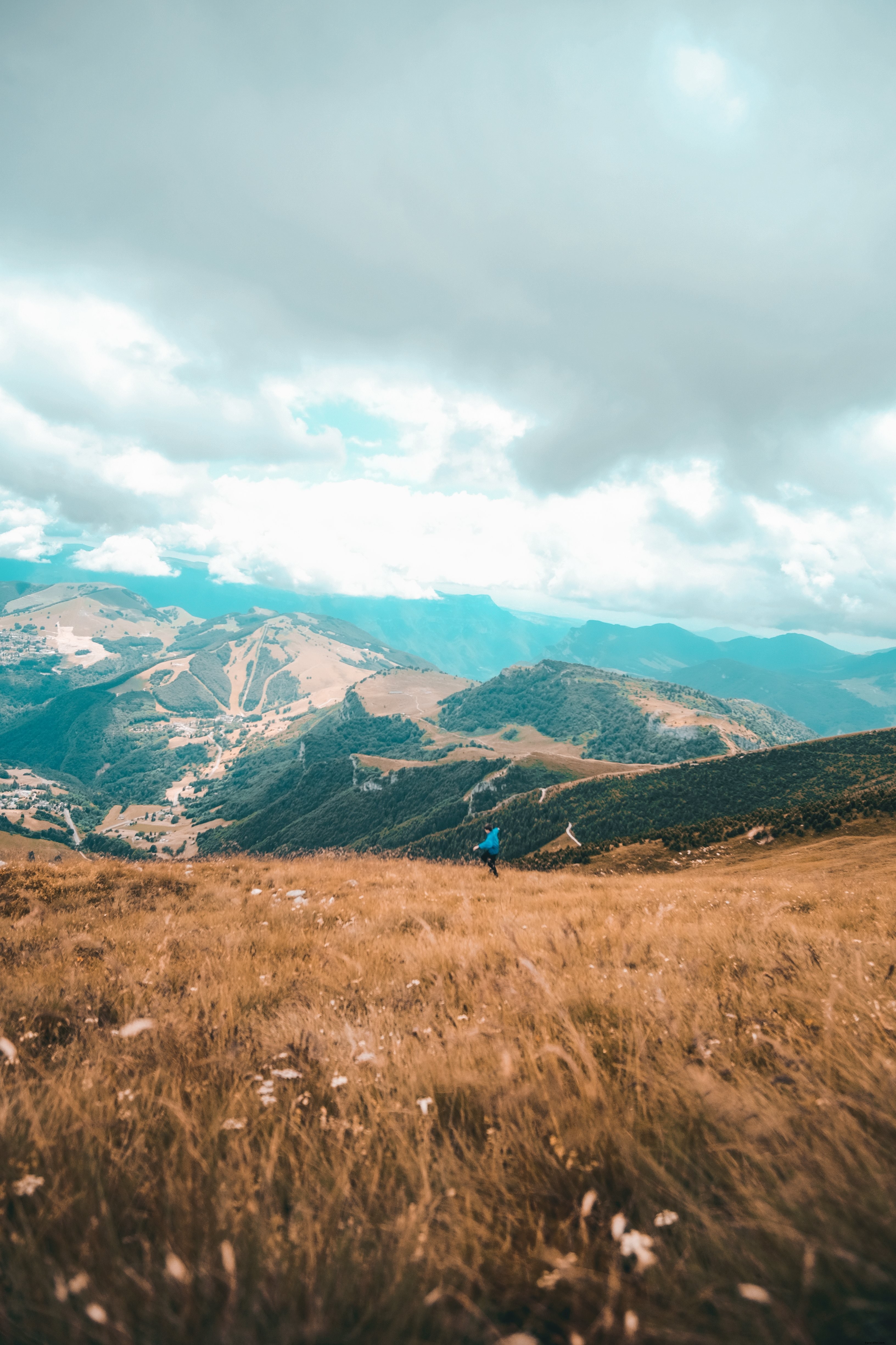 Energetic Dancer on Golden Brown Grassy Hillside – Stunning Scenic Photo