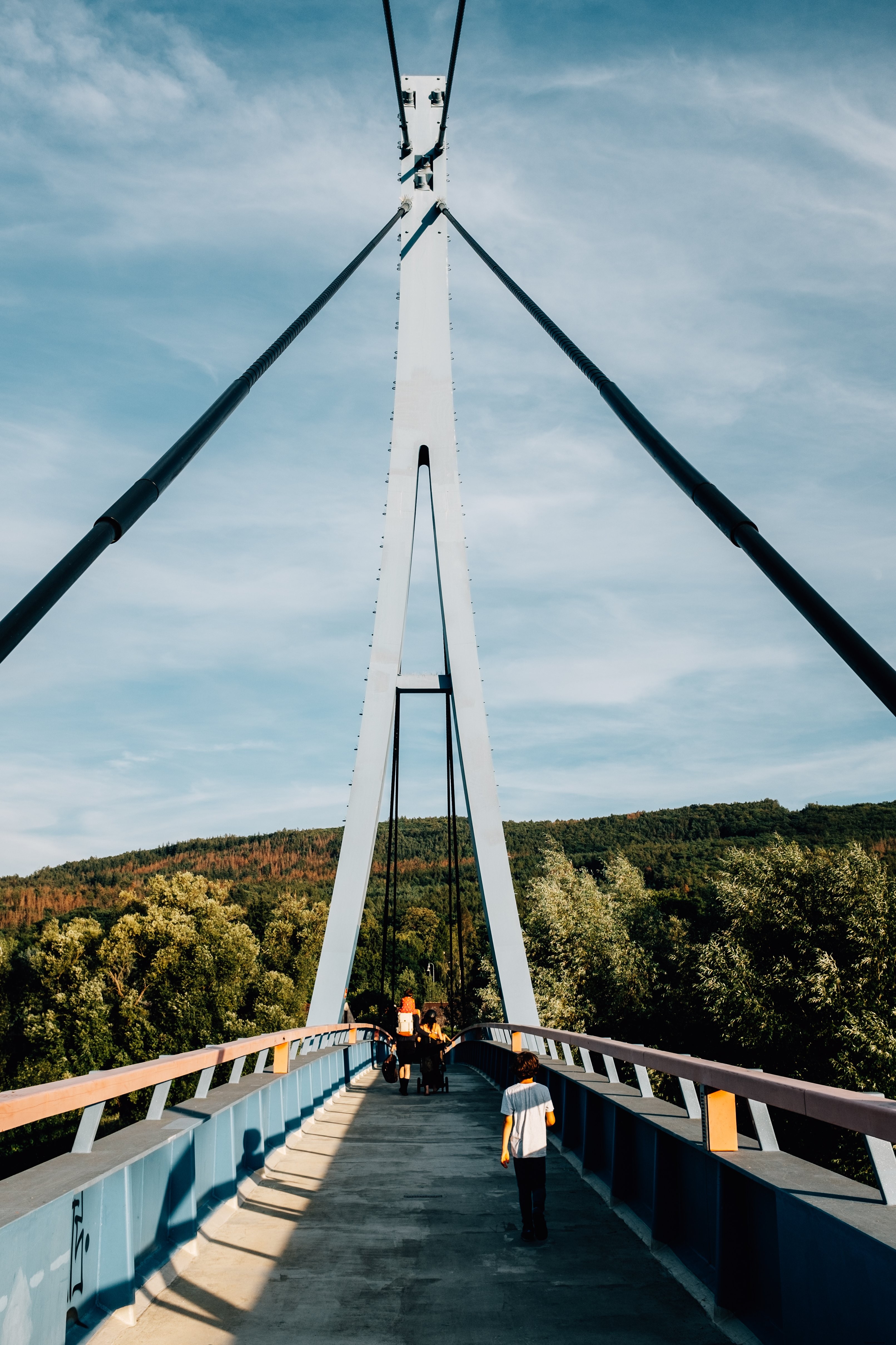 Serene Family Stroll on Bridge Toward Lush Forest – Stunning Photo