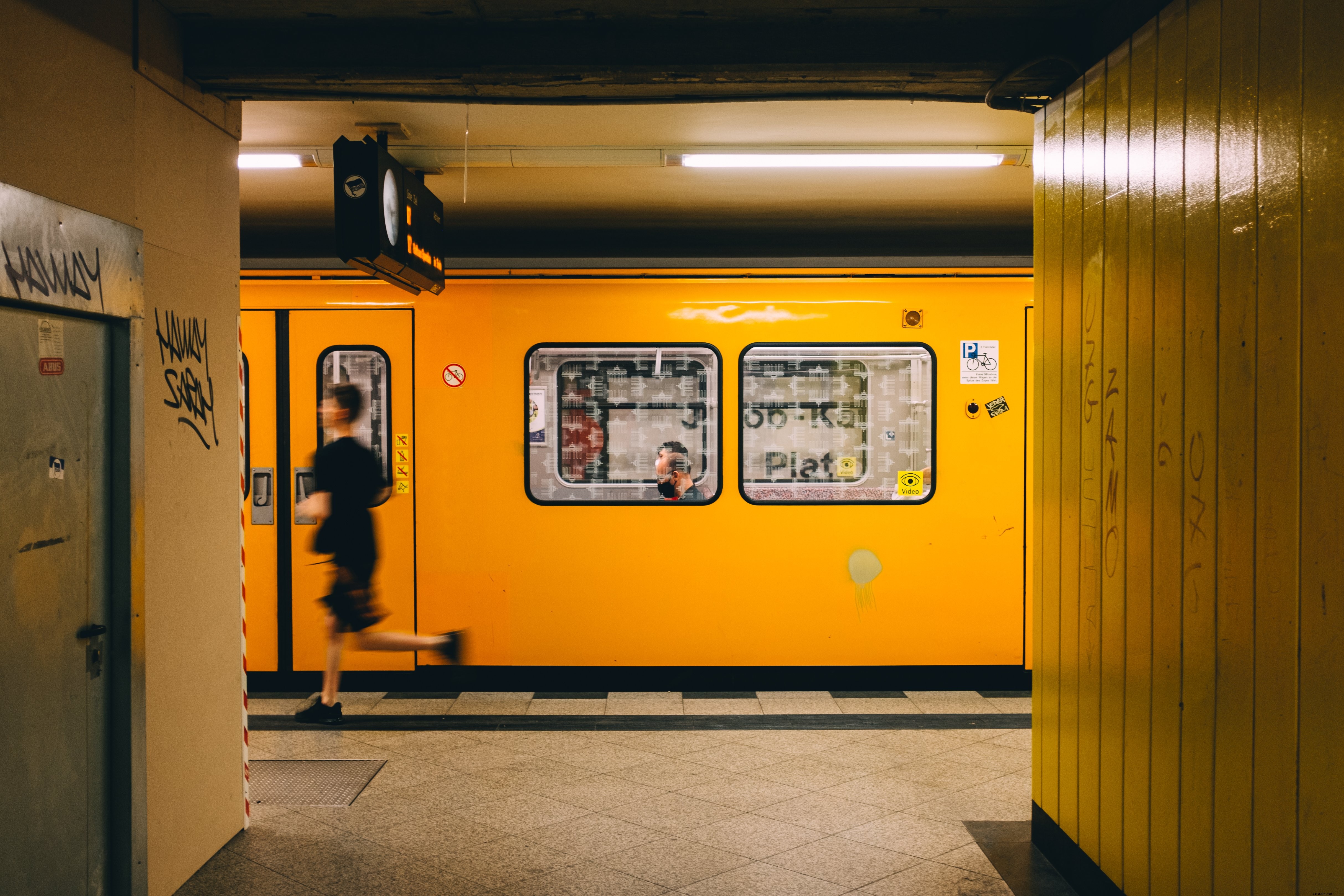 Dynamic Urban Photo: Person Rushing Down Busy Subway Platform