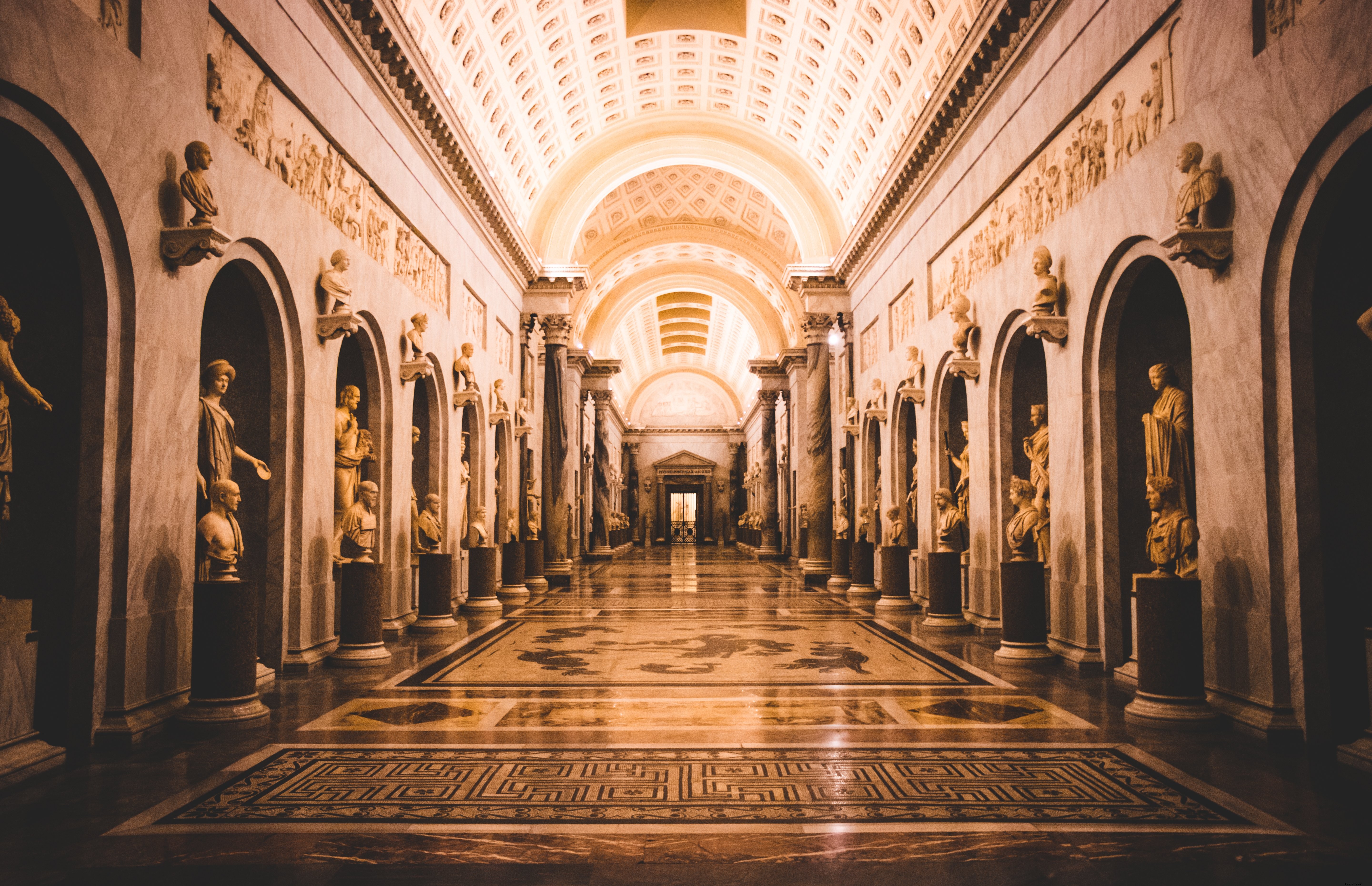 Stunning Illuminated Corridor Lined with Exquisite Statues – Captivating Photo