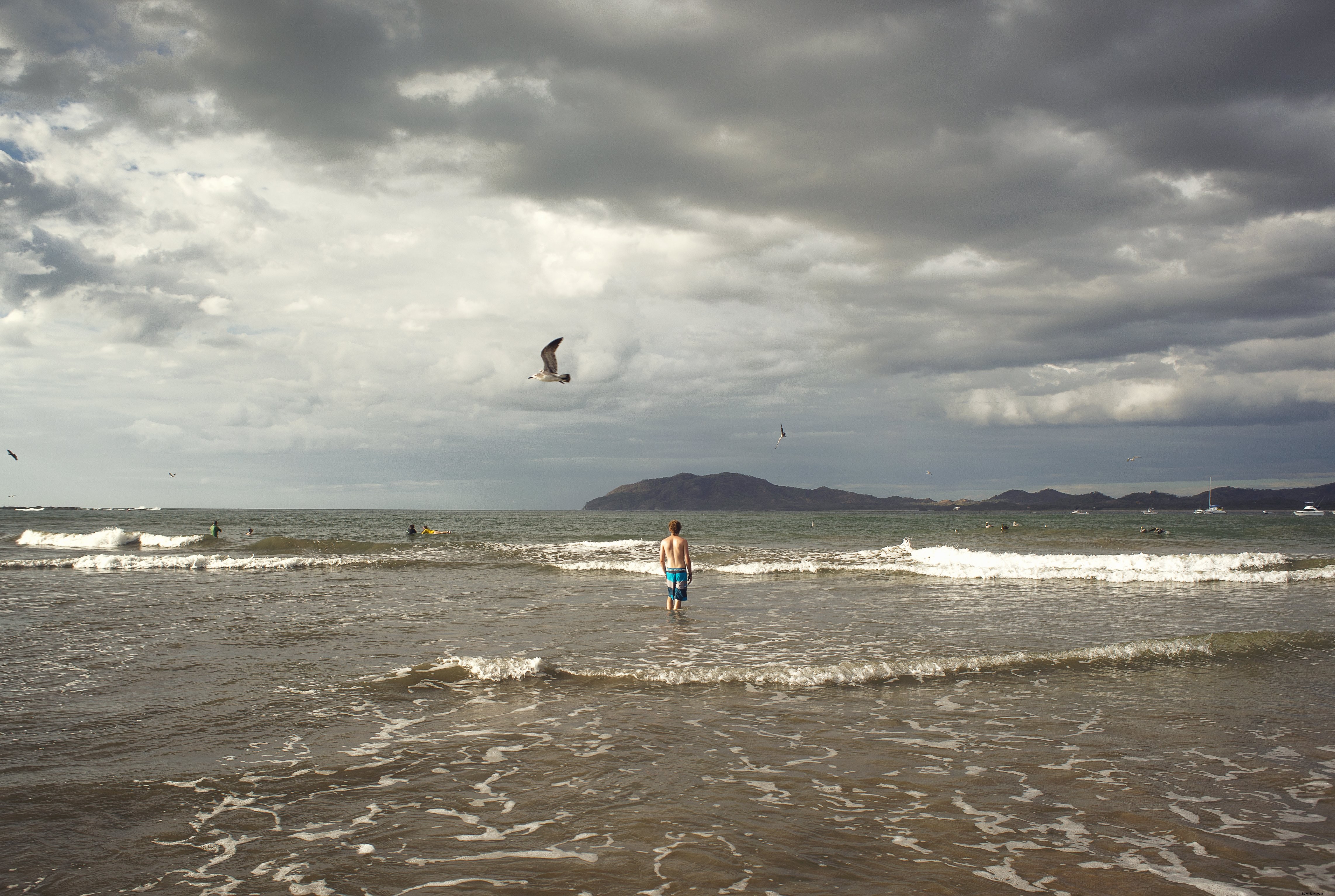 Stunning Beach Scene Under Dramatic Cloudy Skies – High-Quality Photo