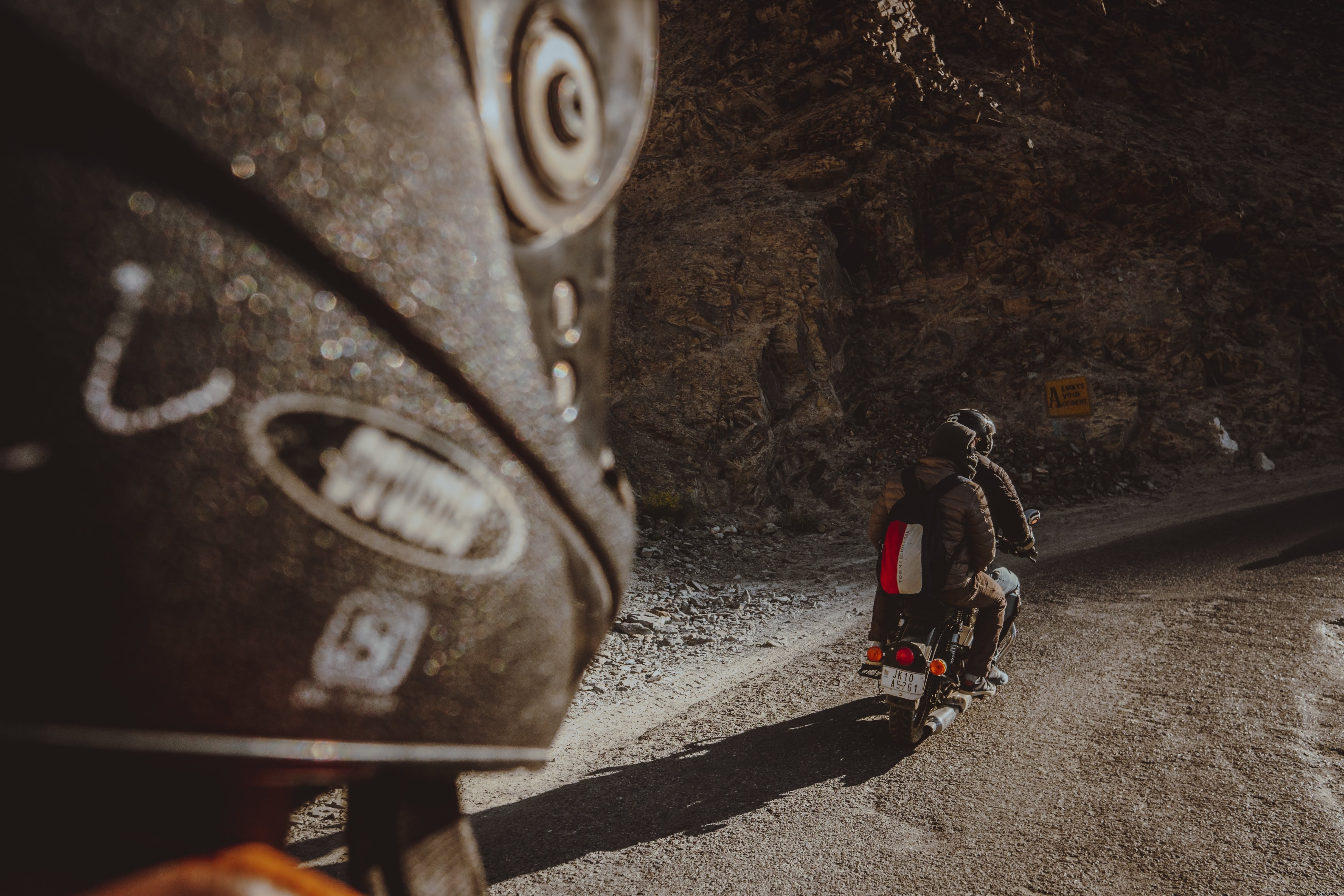 Two Riders on Motorbike Conquering a Rugged Dirt Road – Stunning Photo