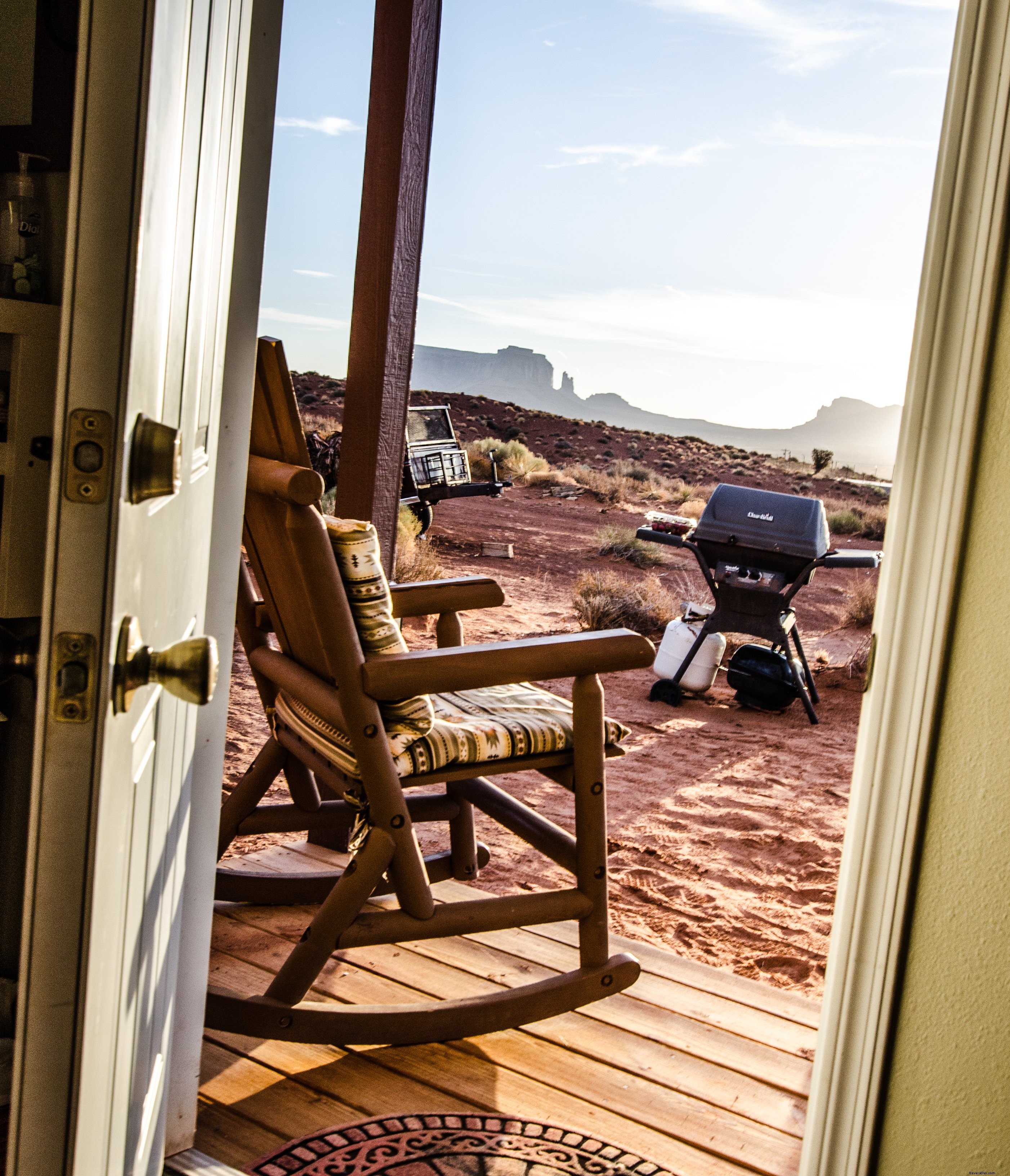 Serene Desert Vista: Rocking Chair on Porch Through Open Door