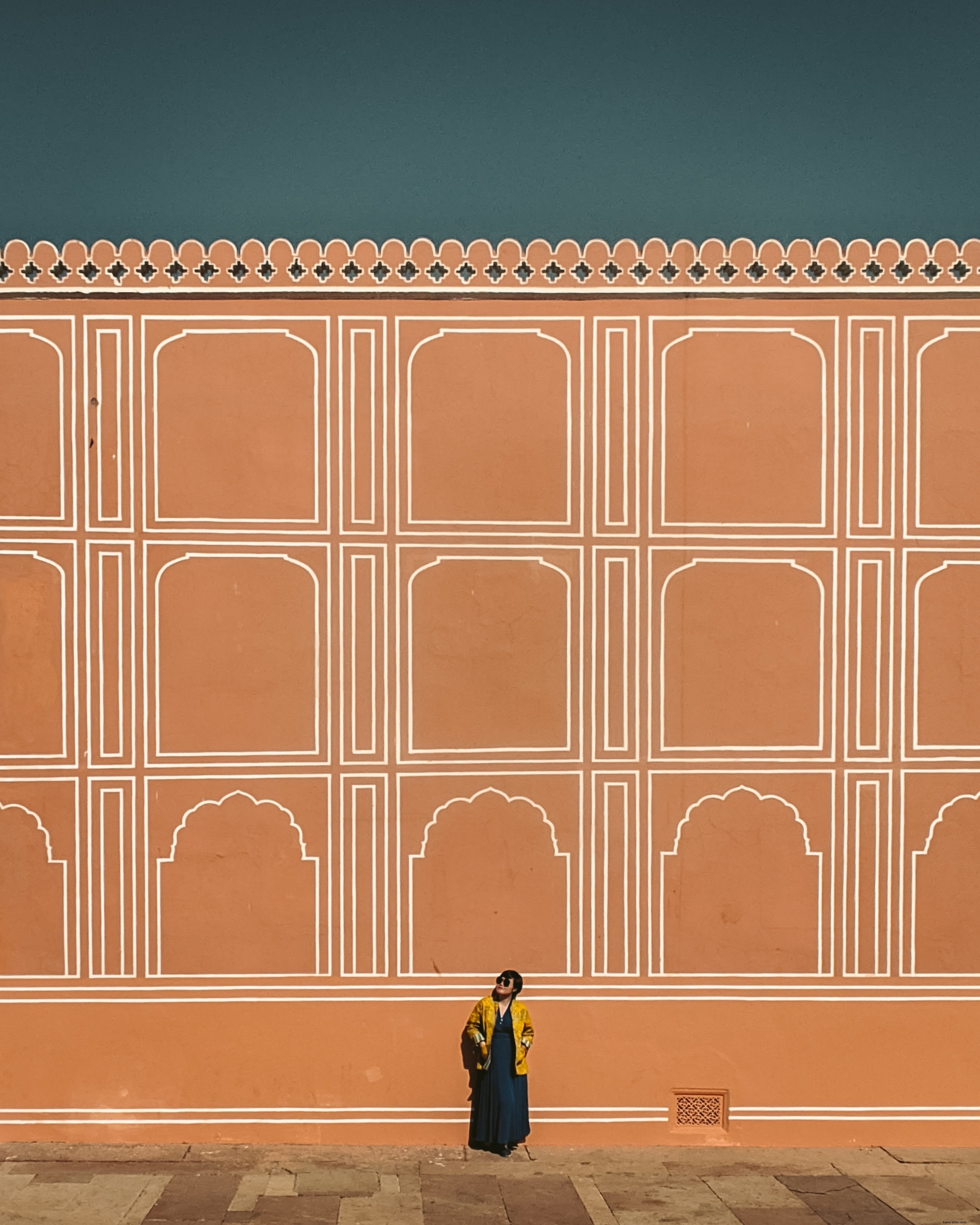 Captivating Photo: Person Gazing Up at Towering Orange Wall