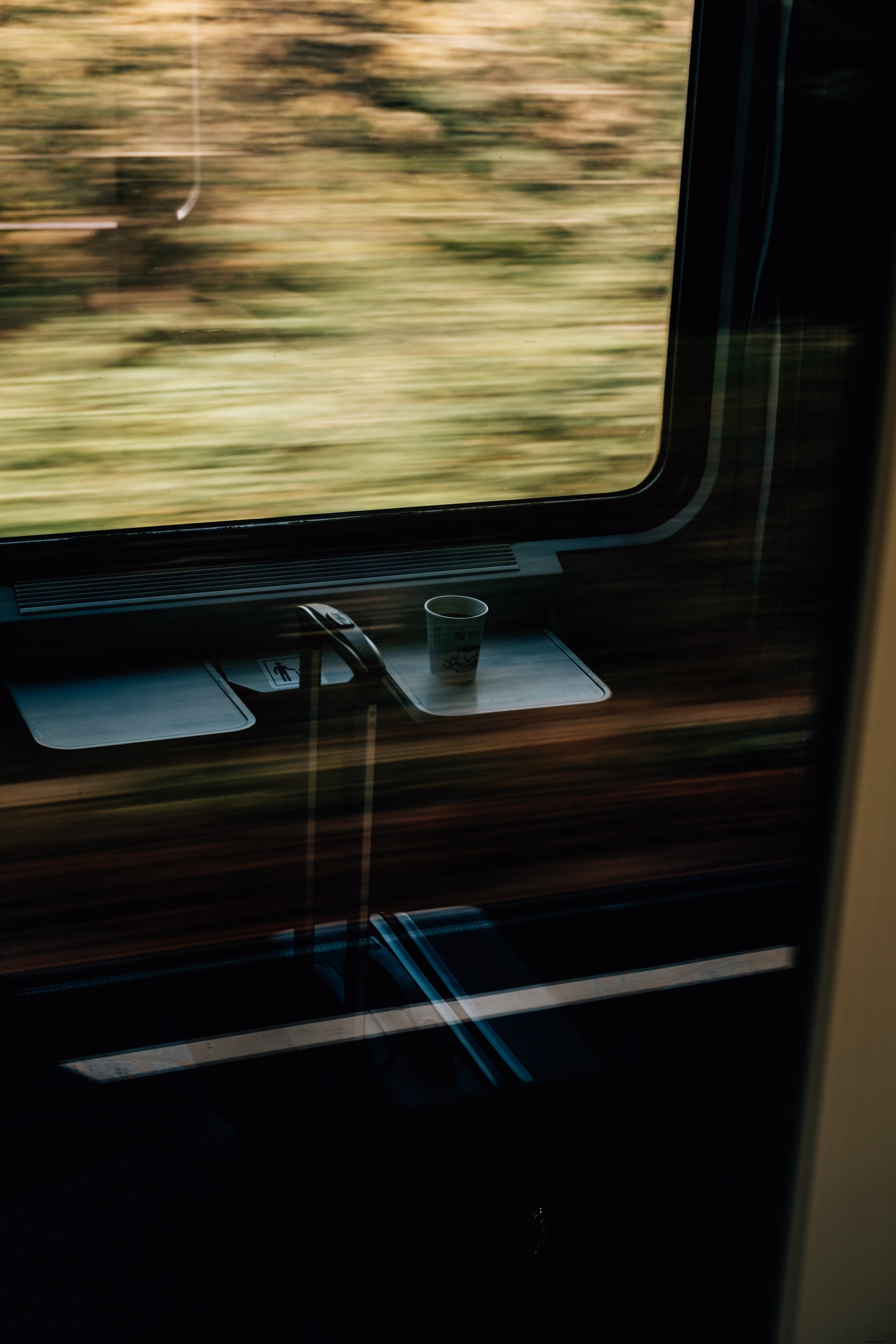 Stunning Motion Photo: White Paper Cup and Suitcase on a High-Speed Train