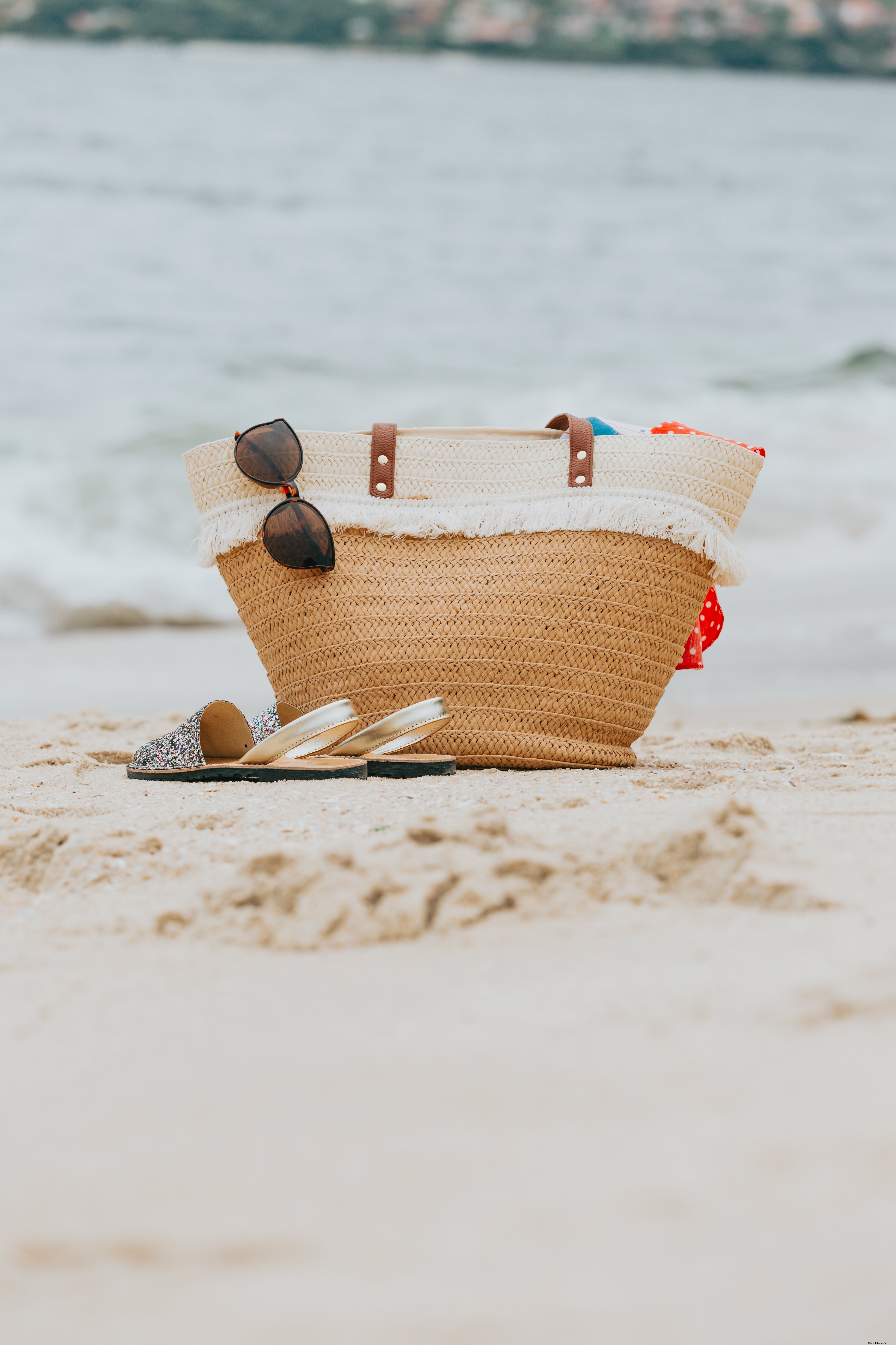 Stylish Wicker Beach Bag and Sandals on Pristine White Sandy Beach – Stunning Photo