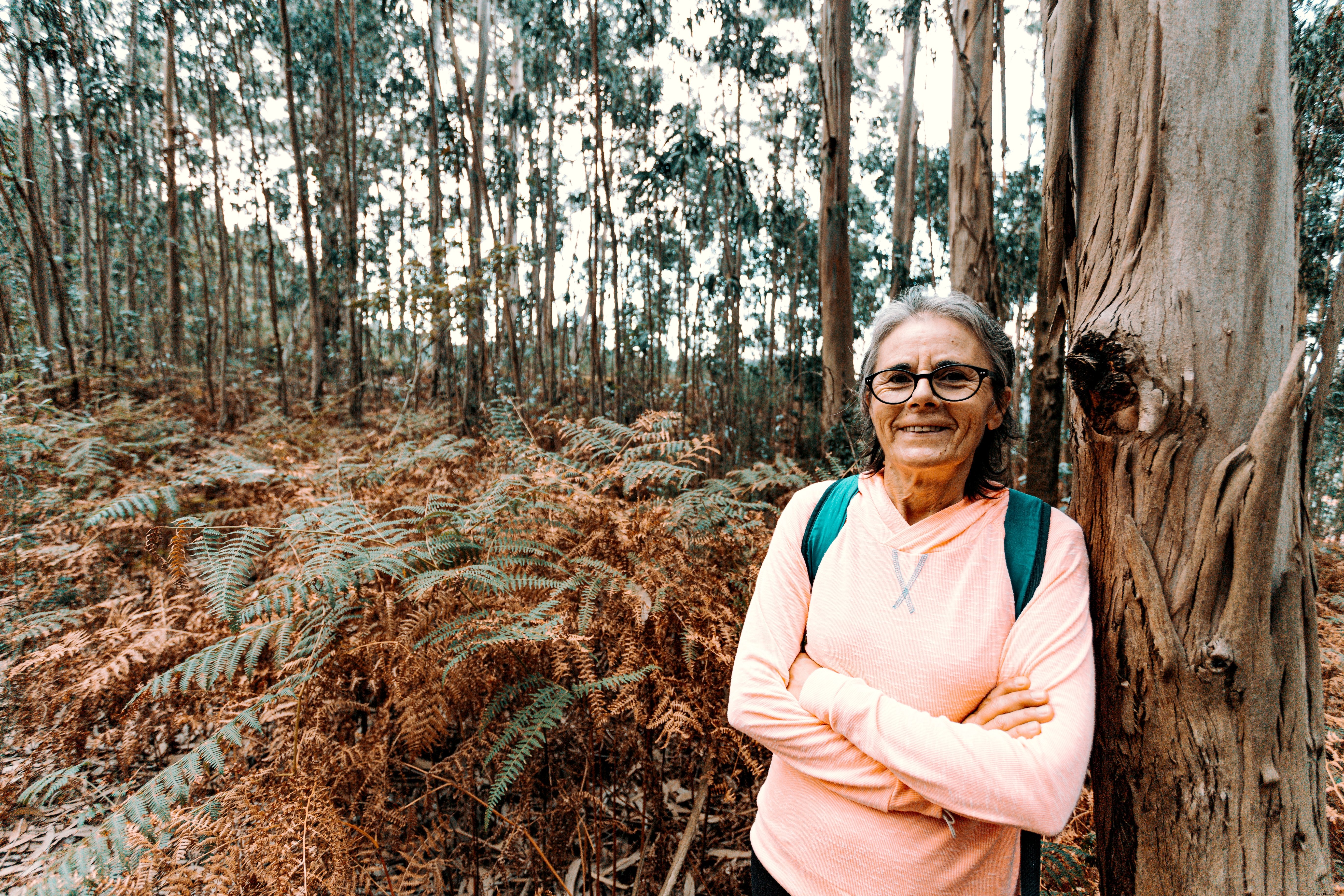 Smiling Woman Leans Against Majestic Large Tree - Stunning Nature Portrait