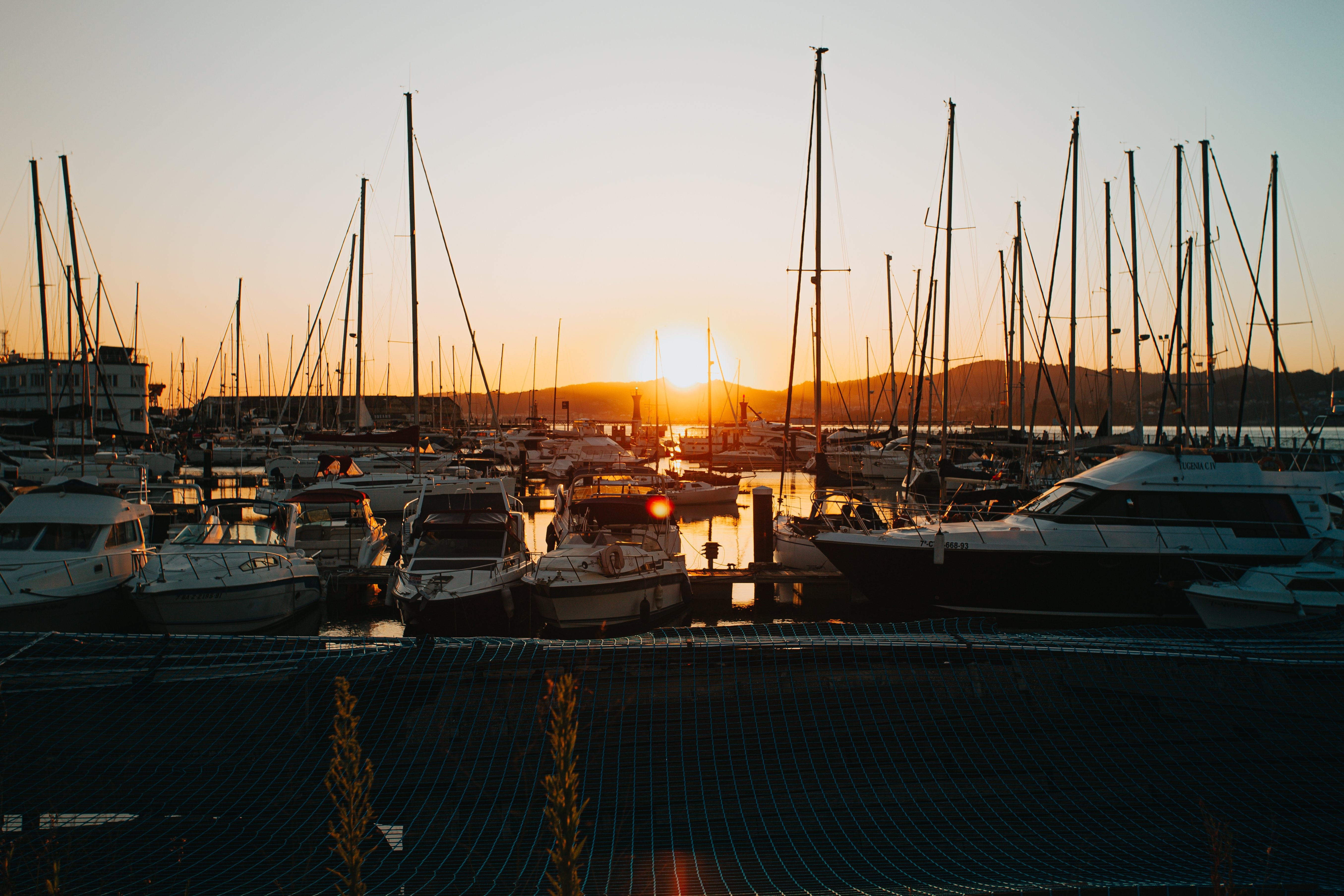 Stunning Sunset Over a Boat-Filled Marina – Captivating Photo