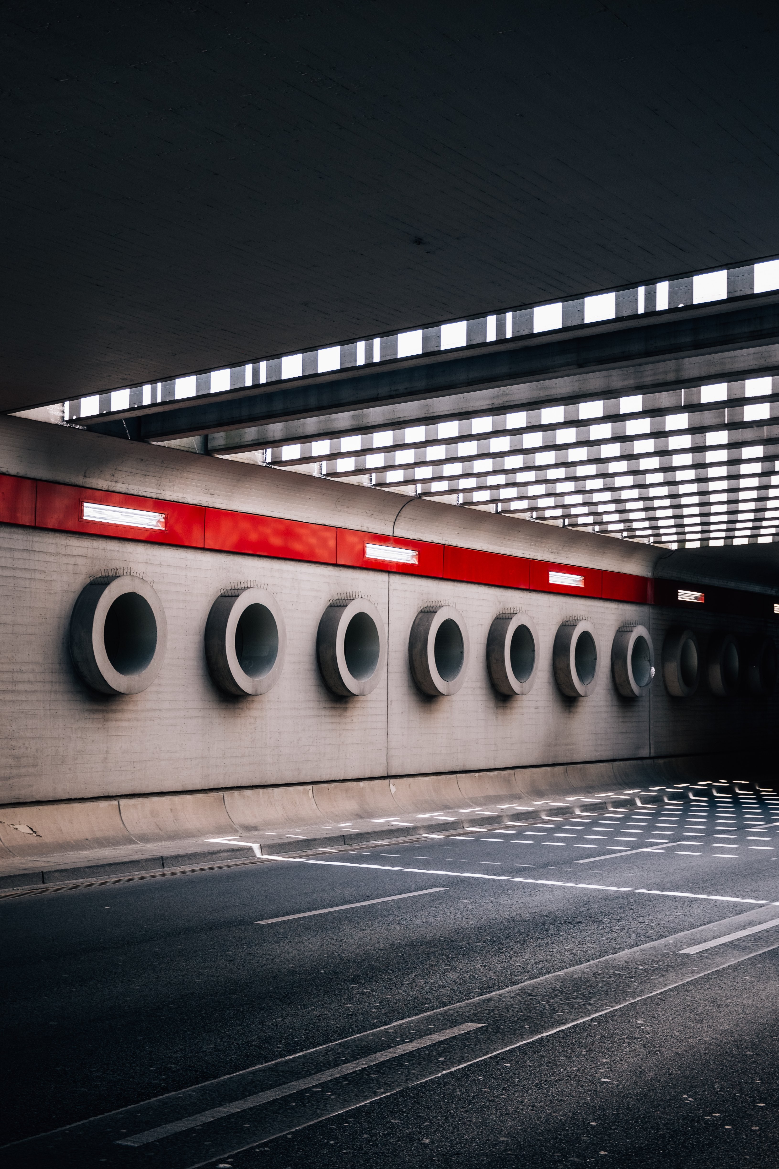 Captivating Cement Circles Lining the Wall Under an Overpass – Stunning Urban Photo