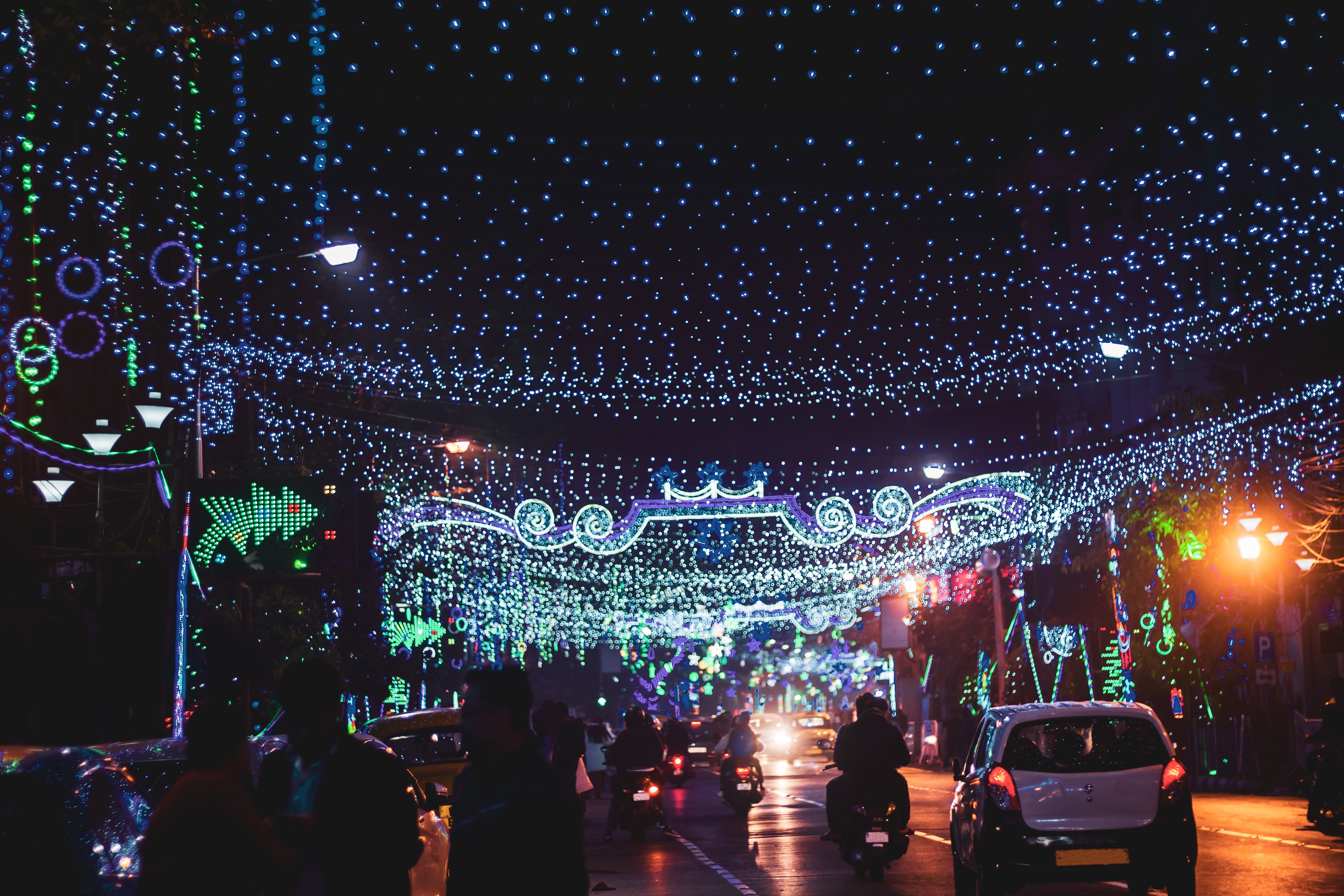 Stunning String Lights Over a Bustling City Road at Night