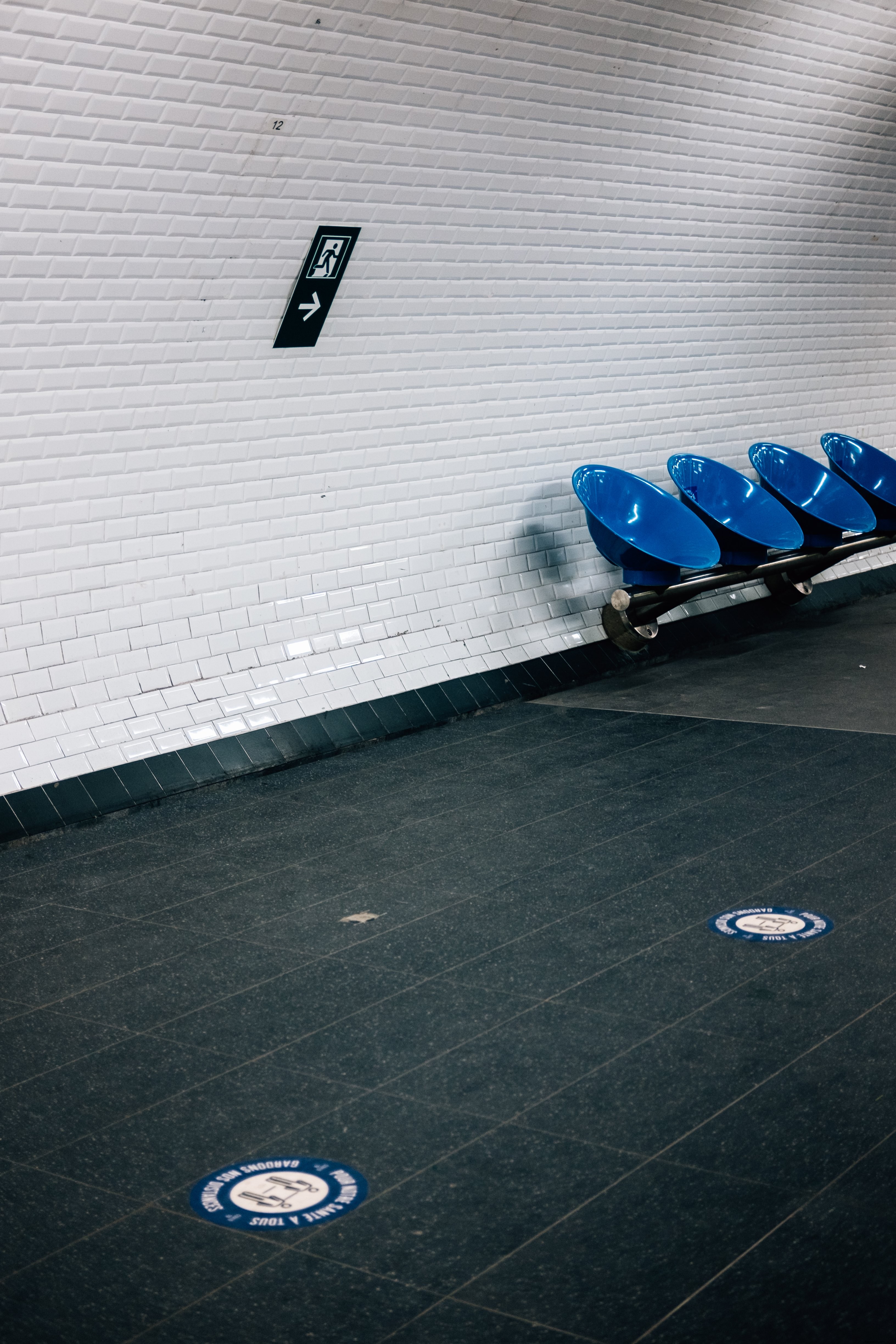 Stunning Photo: White Tiled Wall with Round Blue Chairs