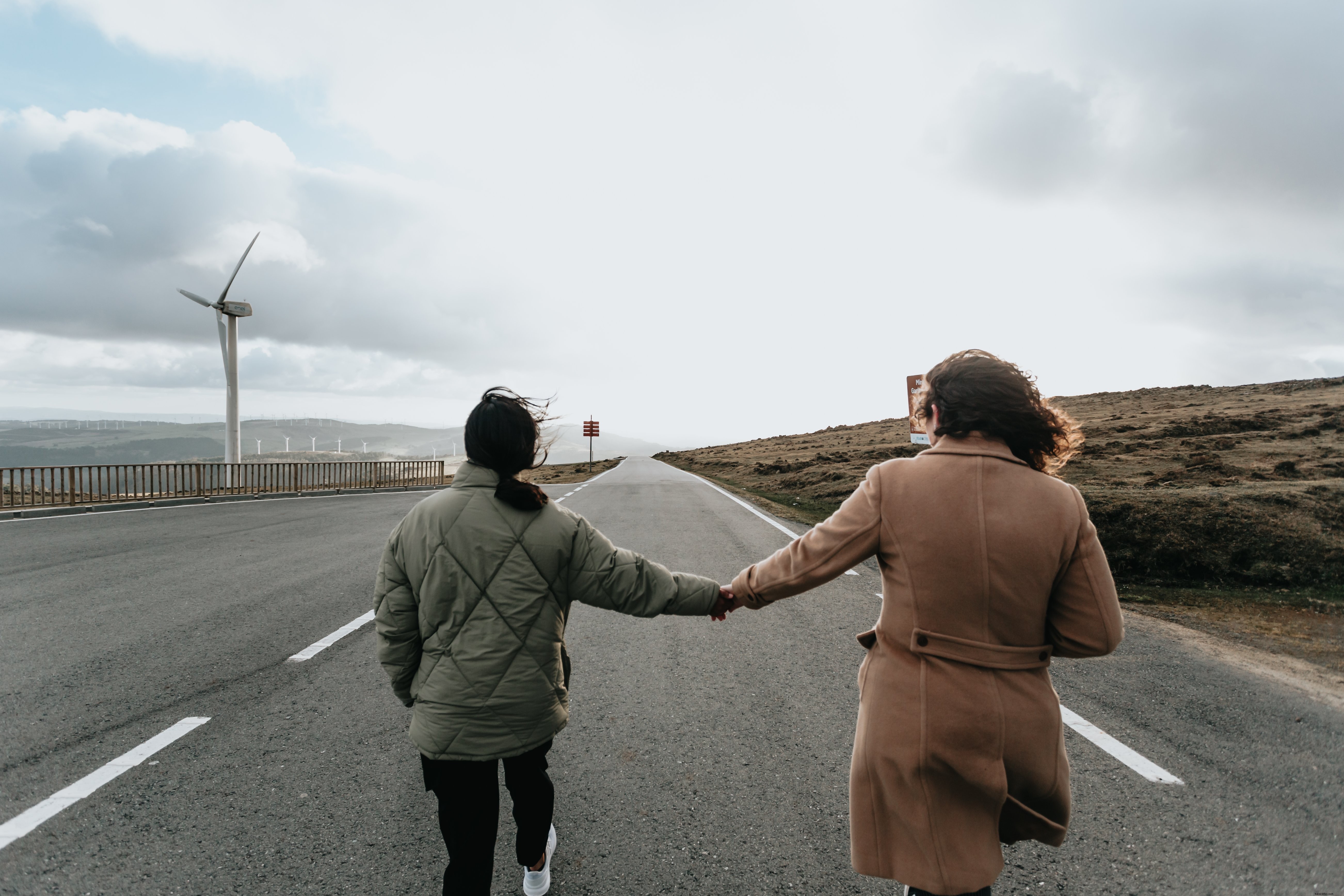 Serene Couple Holding Hands Strolling Down Paved Road – Stunning Stock Photo