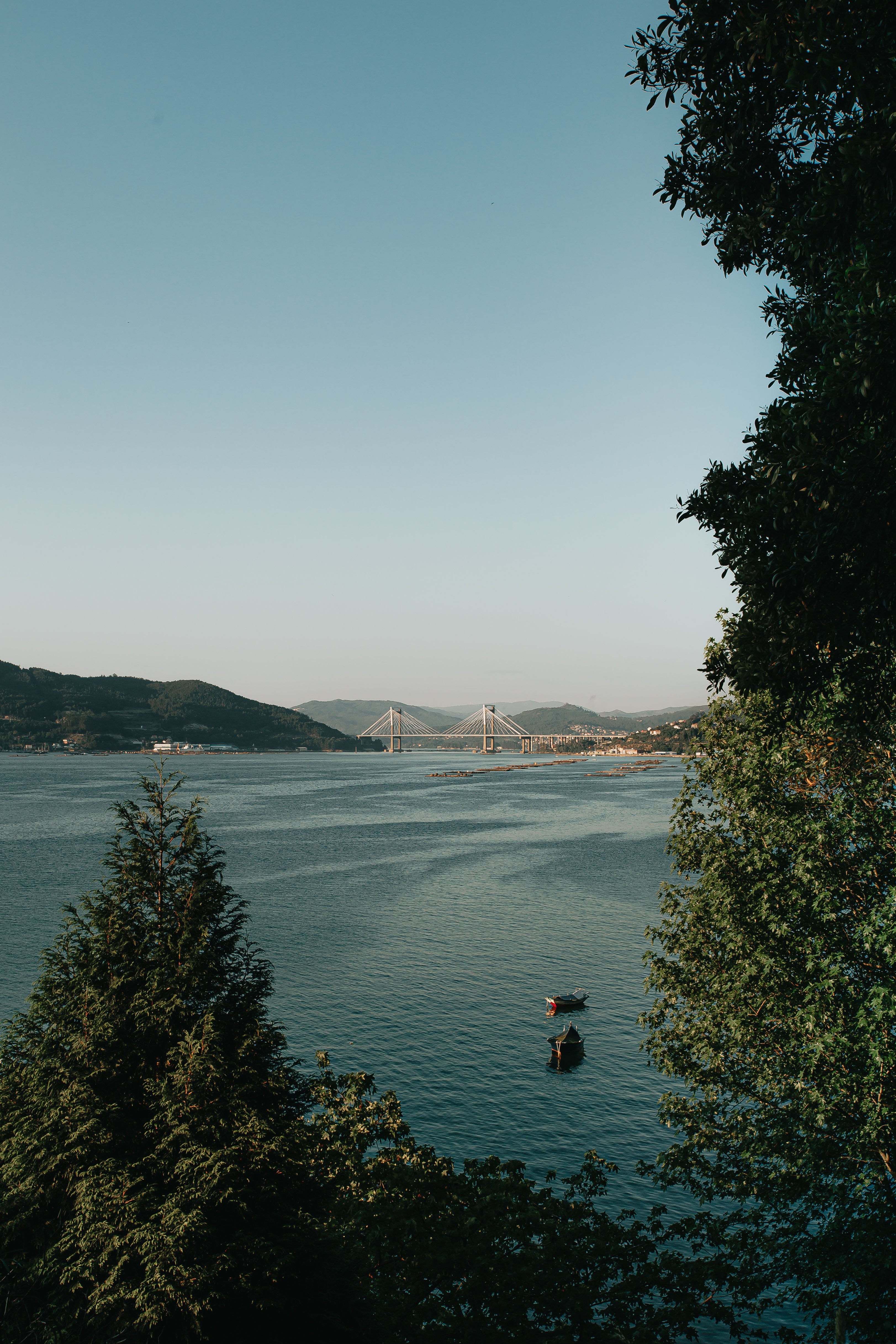 Stunning Hilltop View: Two Boats on Serene Waters Photo