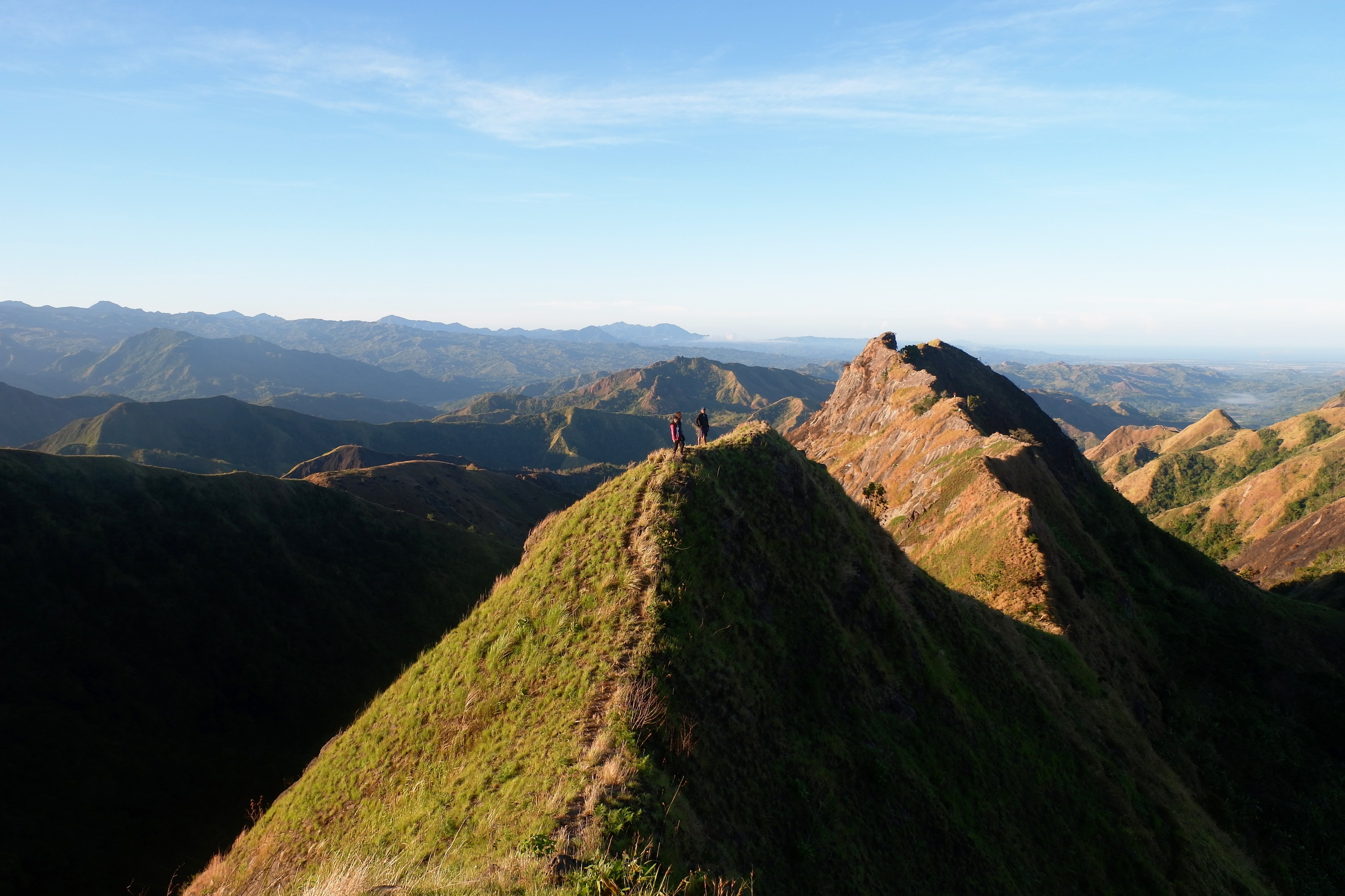 Breathtaking Hikers Traversing Majestic Mountain Peak Photo