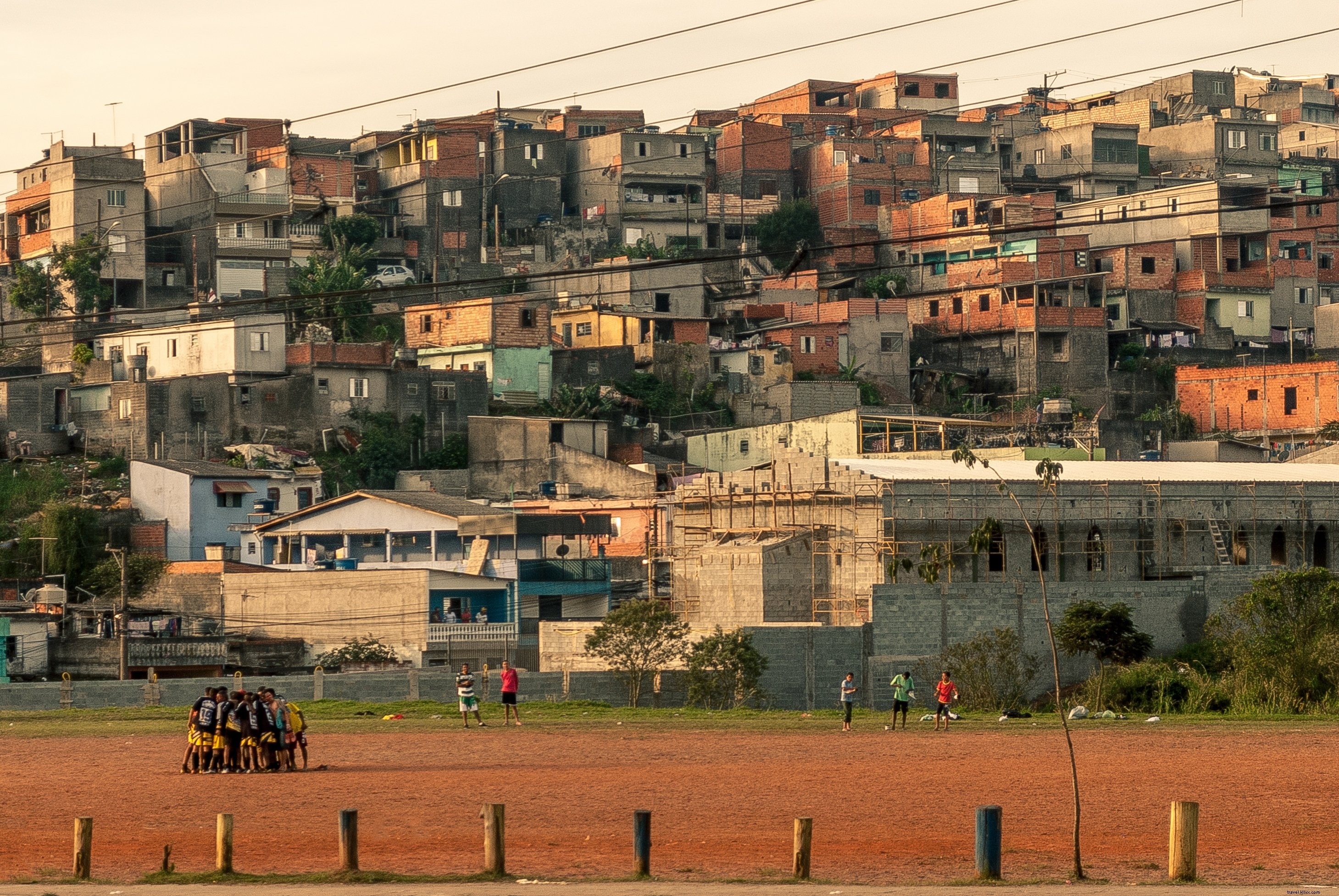 Striking Photo: People Huddled Together on Rust-Colored Field