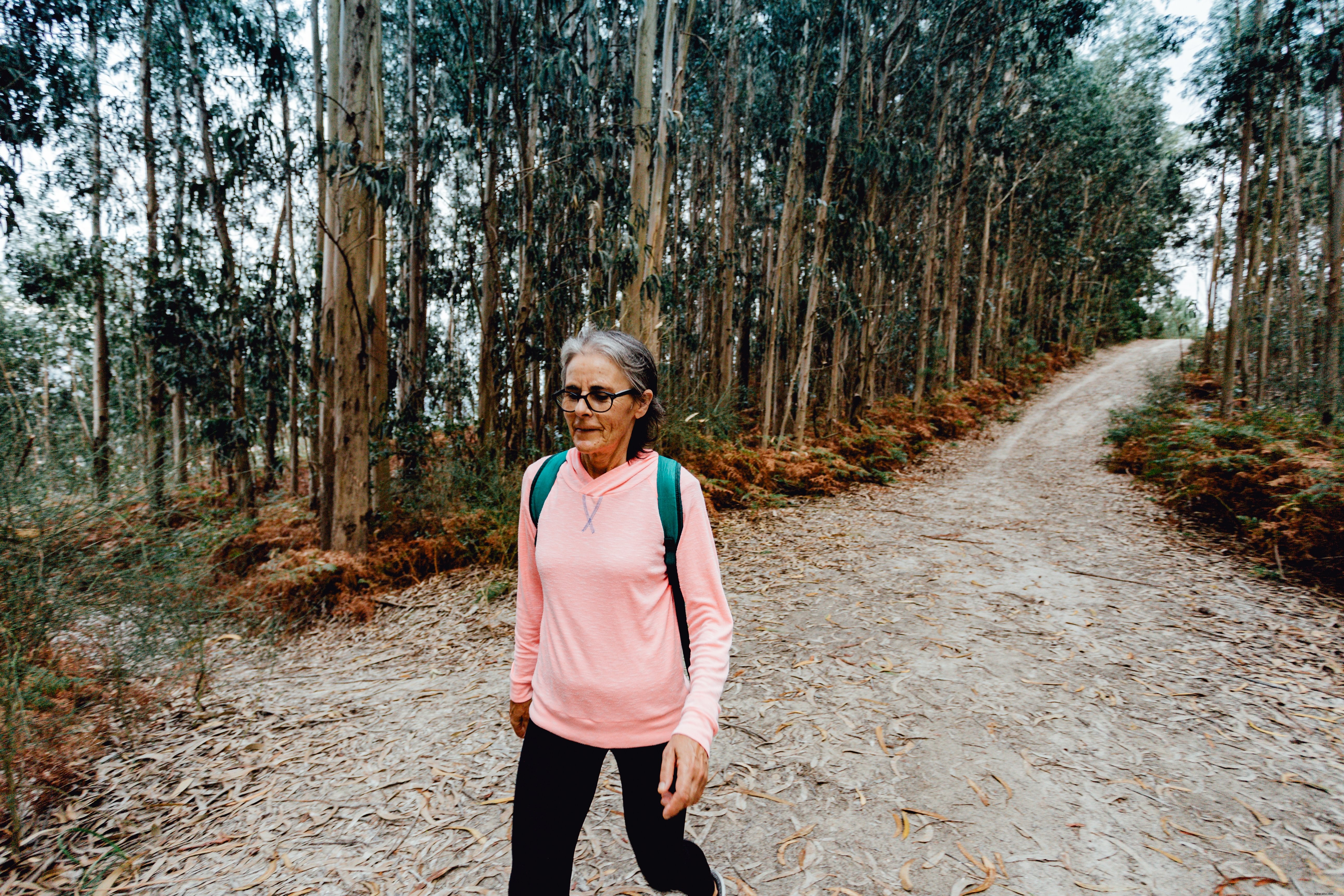 Serene Woman Strolling Down Tree-Lined Path – Stunning Nature Photo