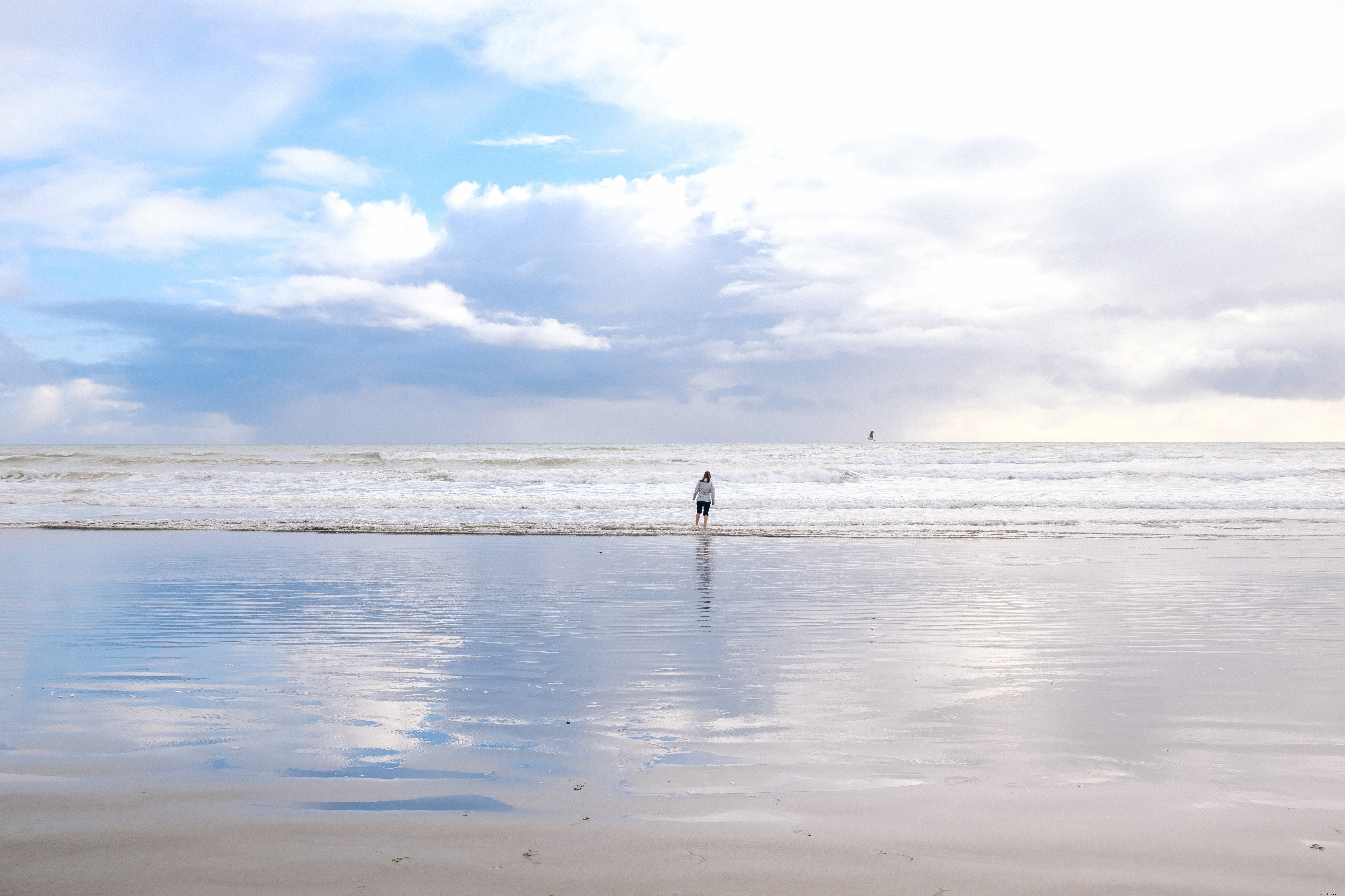 Woman Takes a Dip in Seaside Waters – Stunning Beach Moment