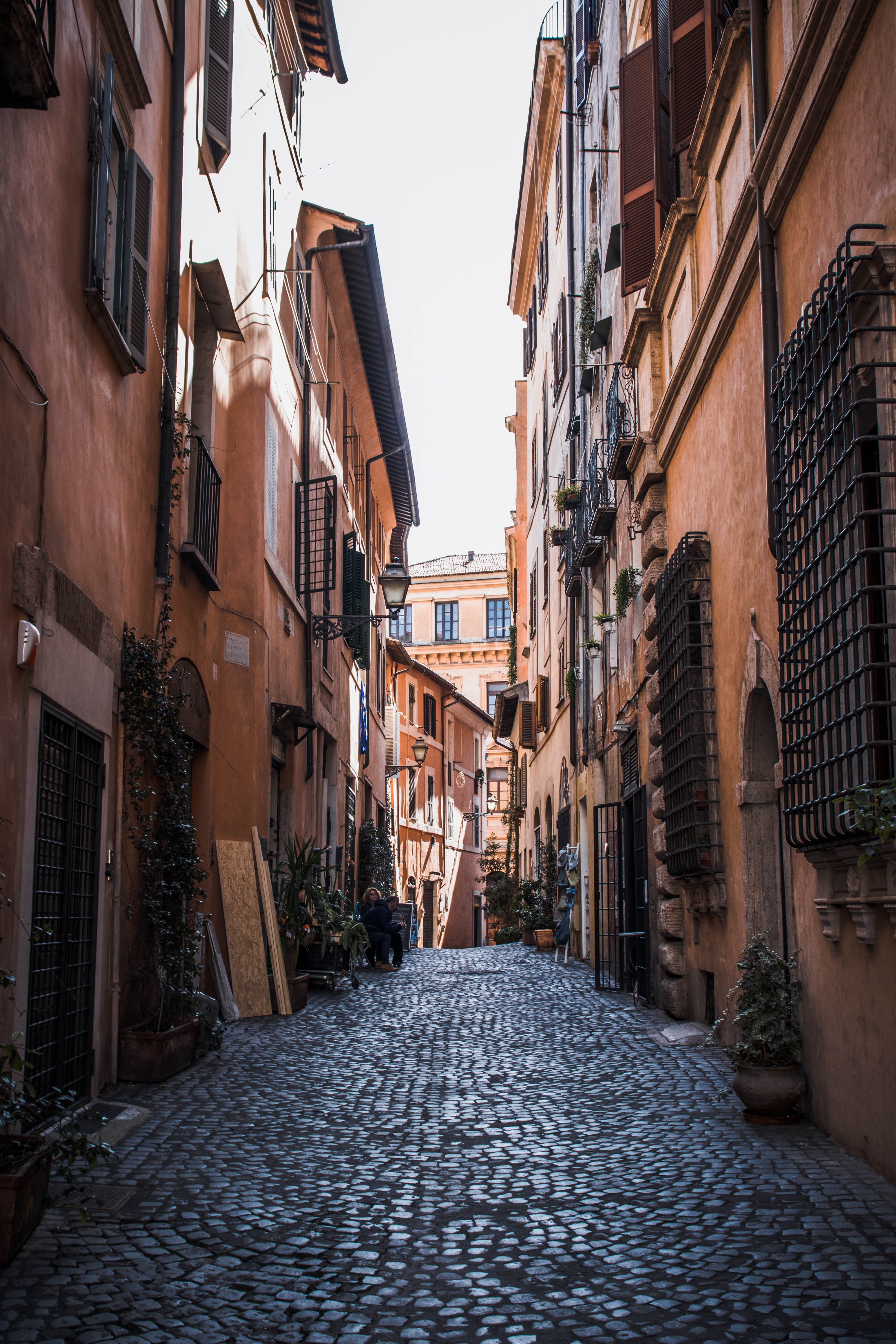 Vibrant Orange Buildings Line a Picturesque Cobblestone Street – Stunning Photo
