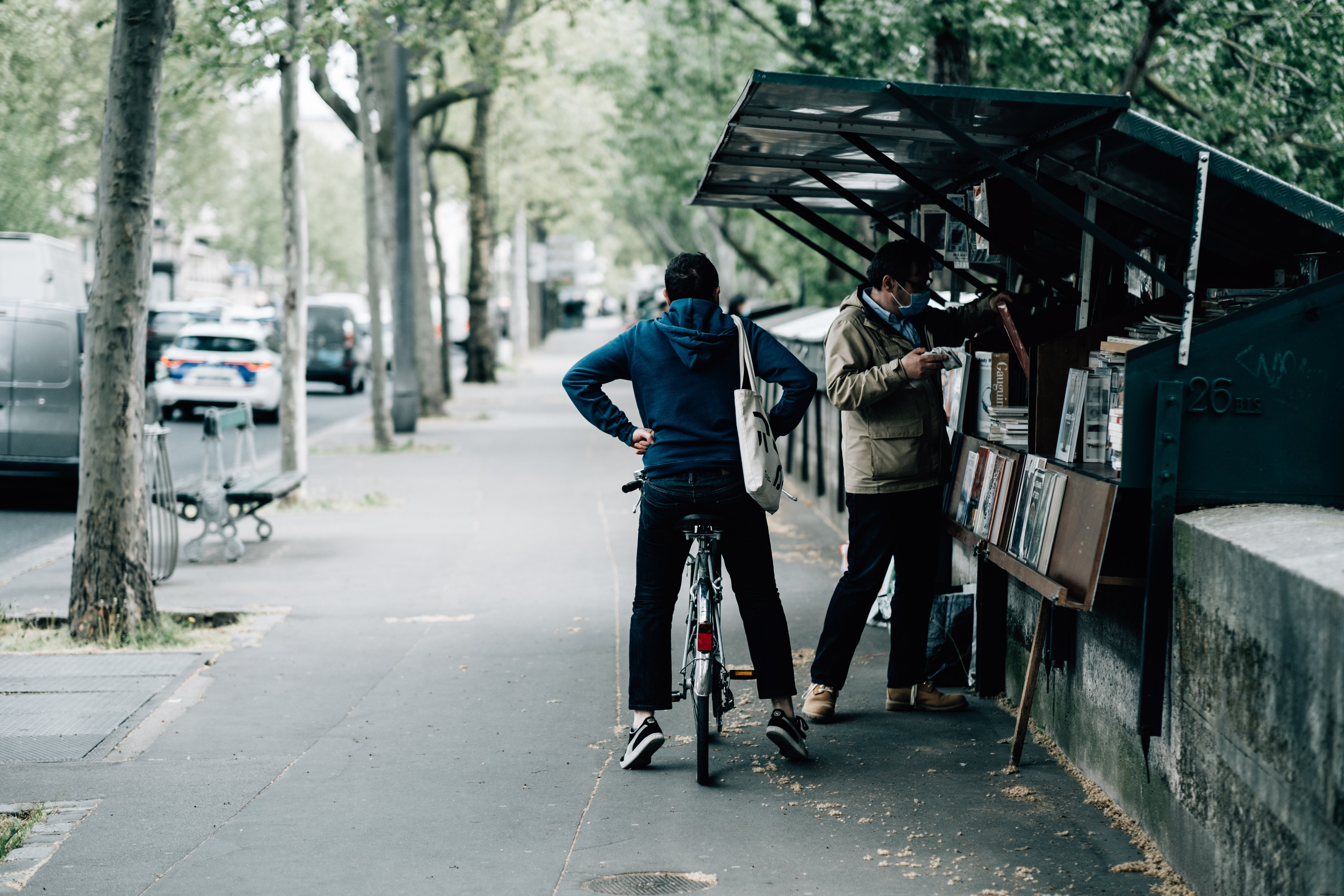 Cyclist Patiently Waits for Friend at Bookstore – Captivating Street Photo