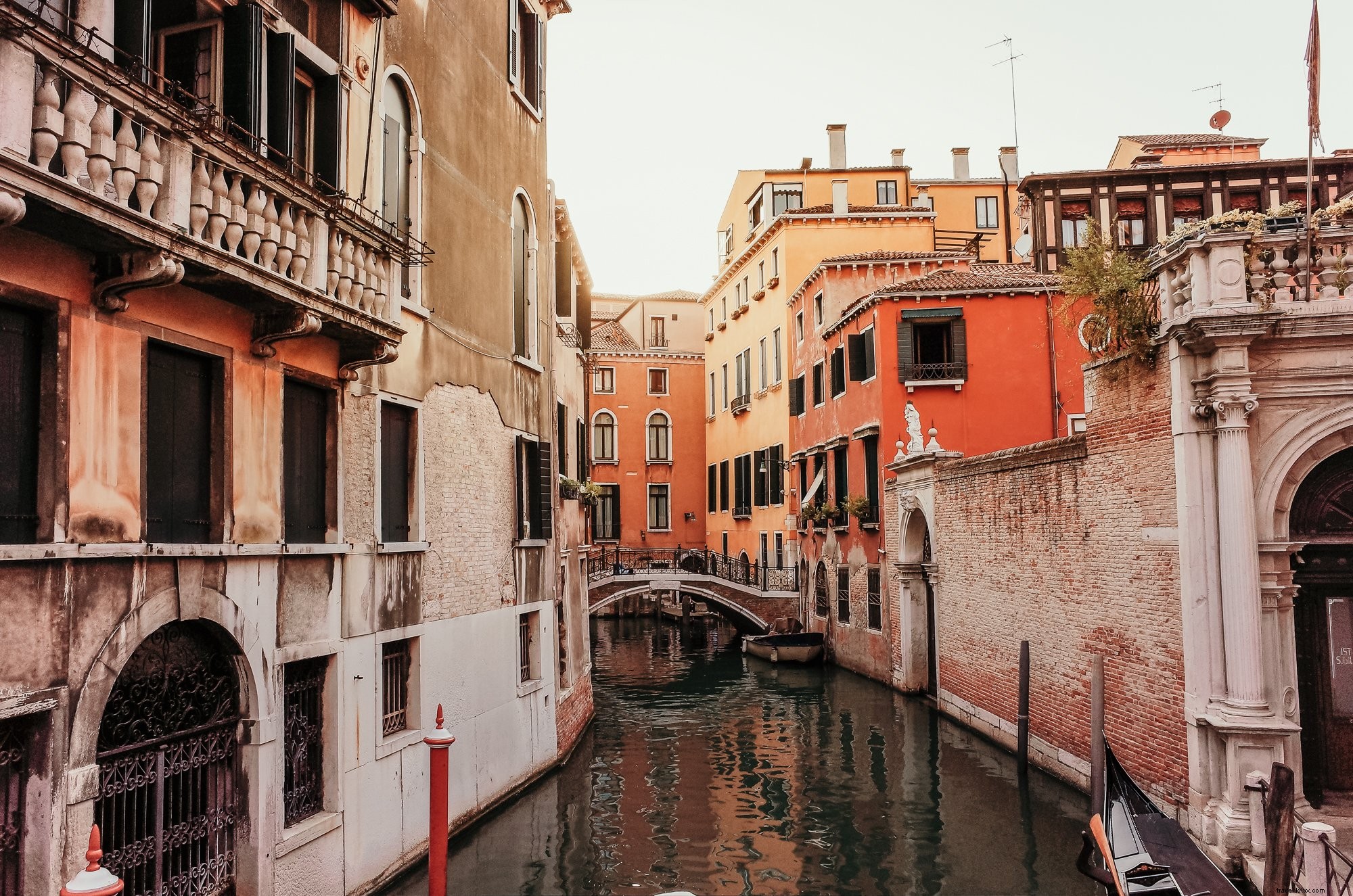 Stunning Photo of Serene Canal Between Urban Buildings with Elegant Bridge