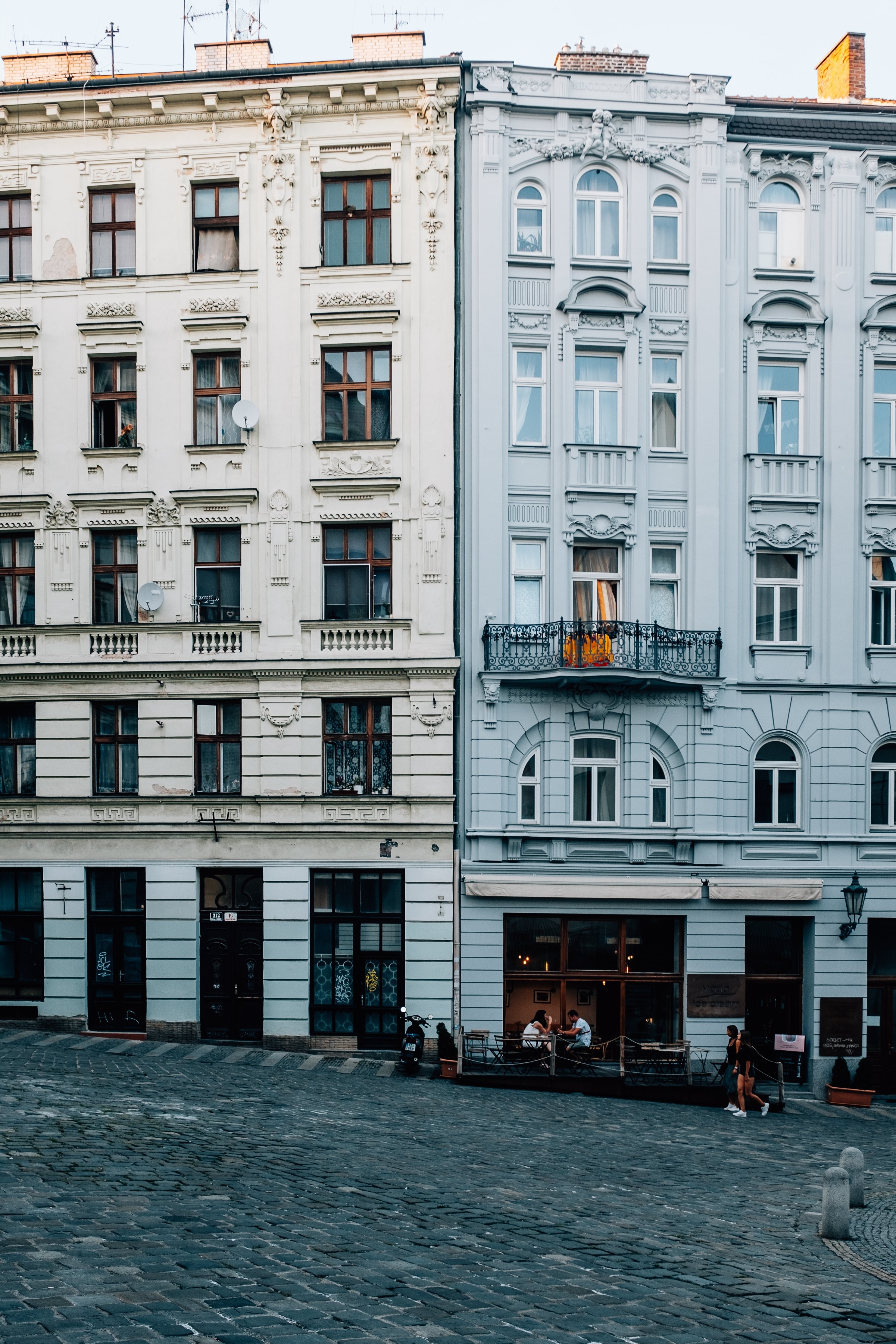 Picturesque Cobblestone Street Lined with Tall White Buildings – Stunning Photo