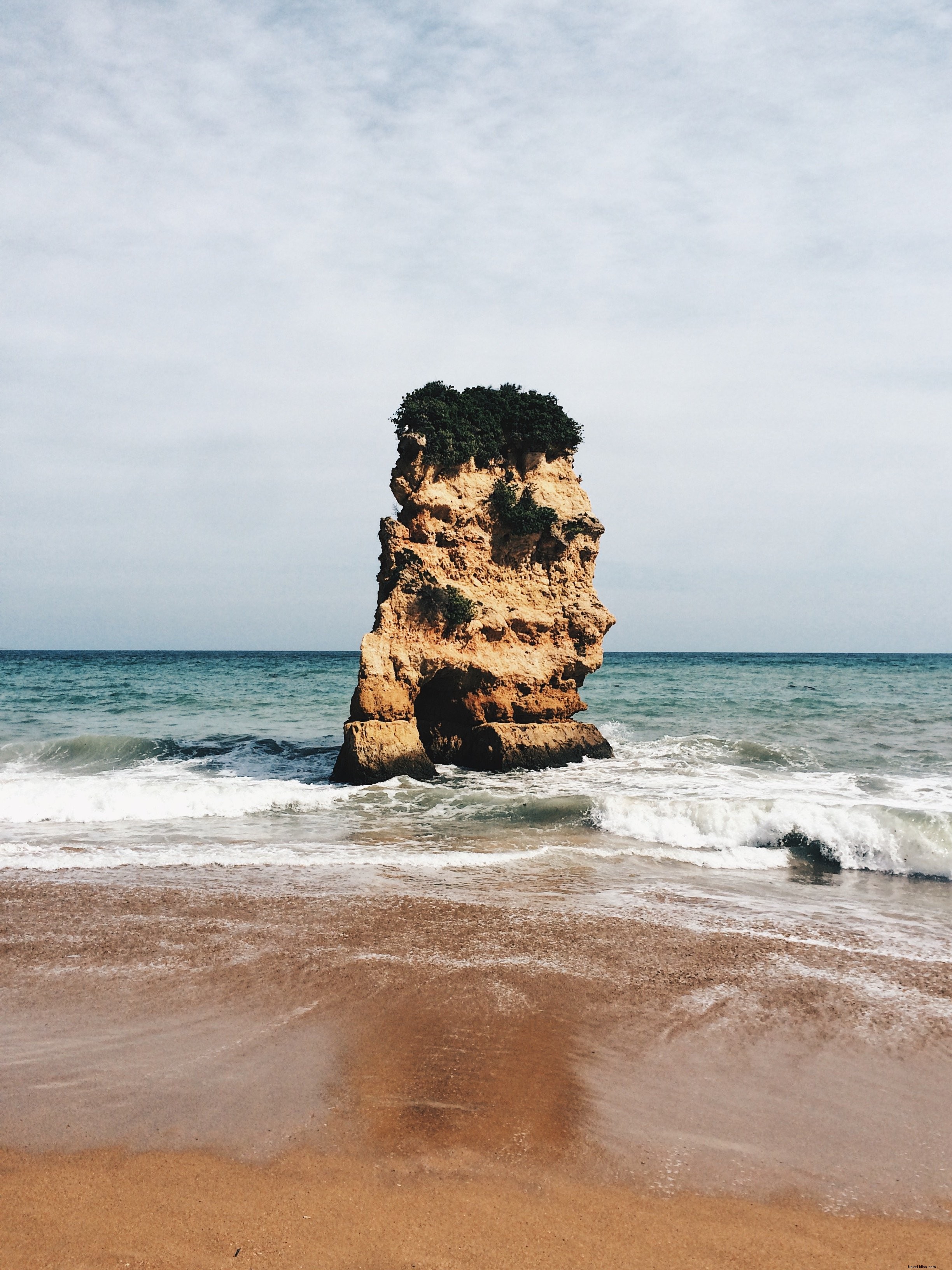 Majestic Giant Rock Standing Sentinel in the Vast Ocean – Stunning Photo