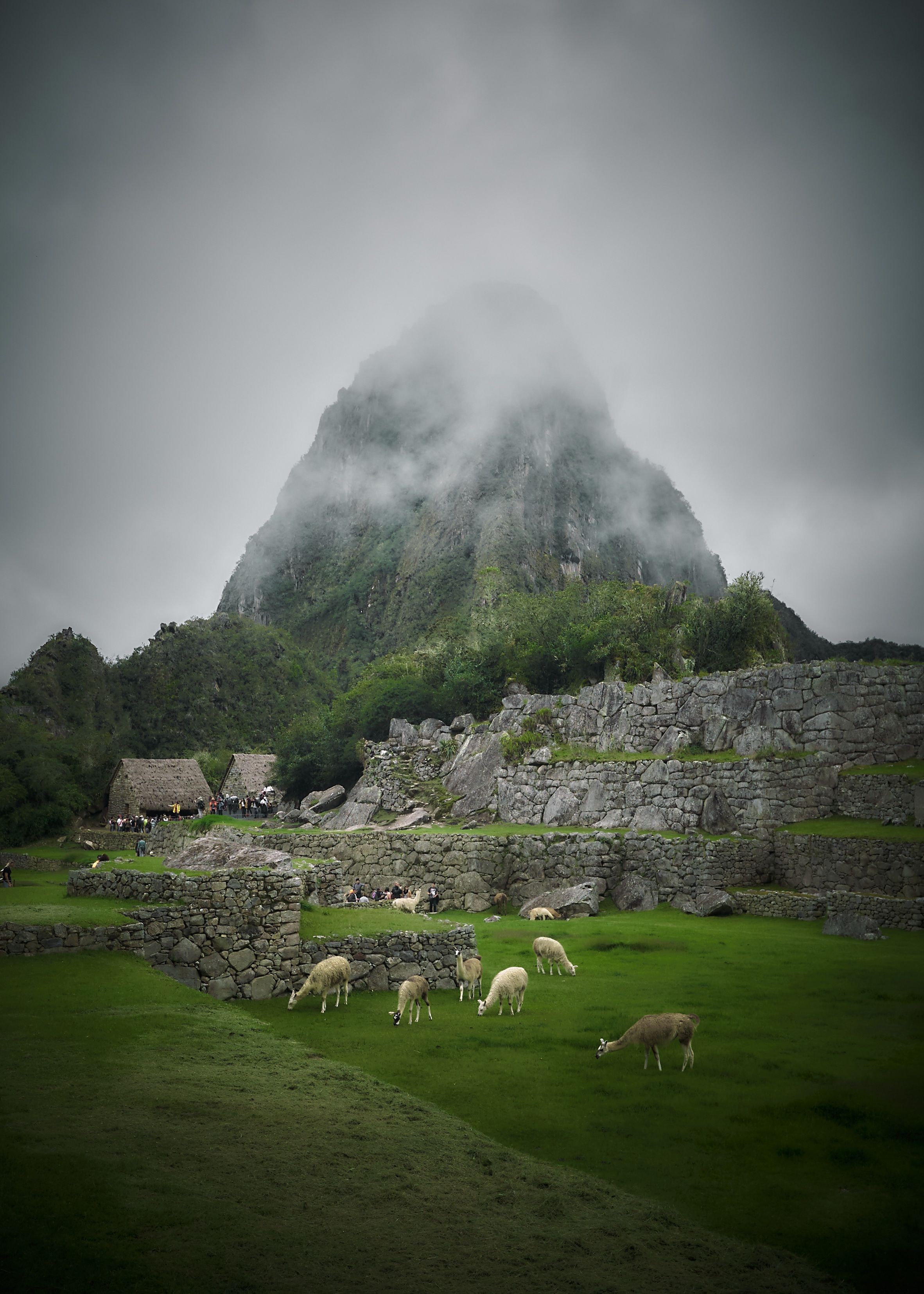 Dramatic Heavy Clouds Rolling Over Majestic Mountains – Stunning Photo