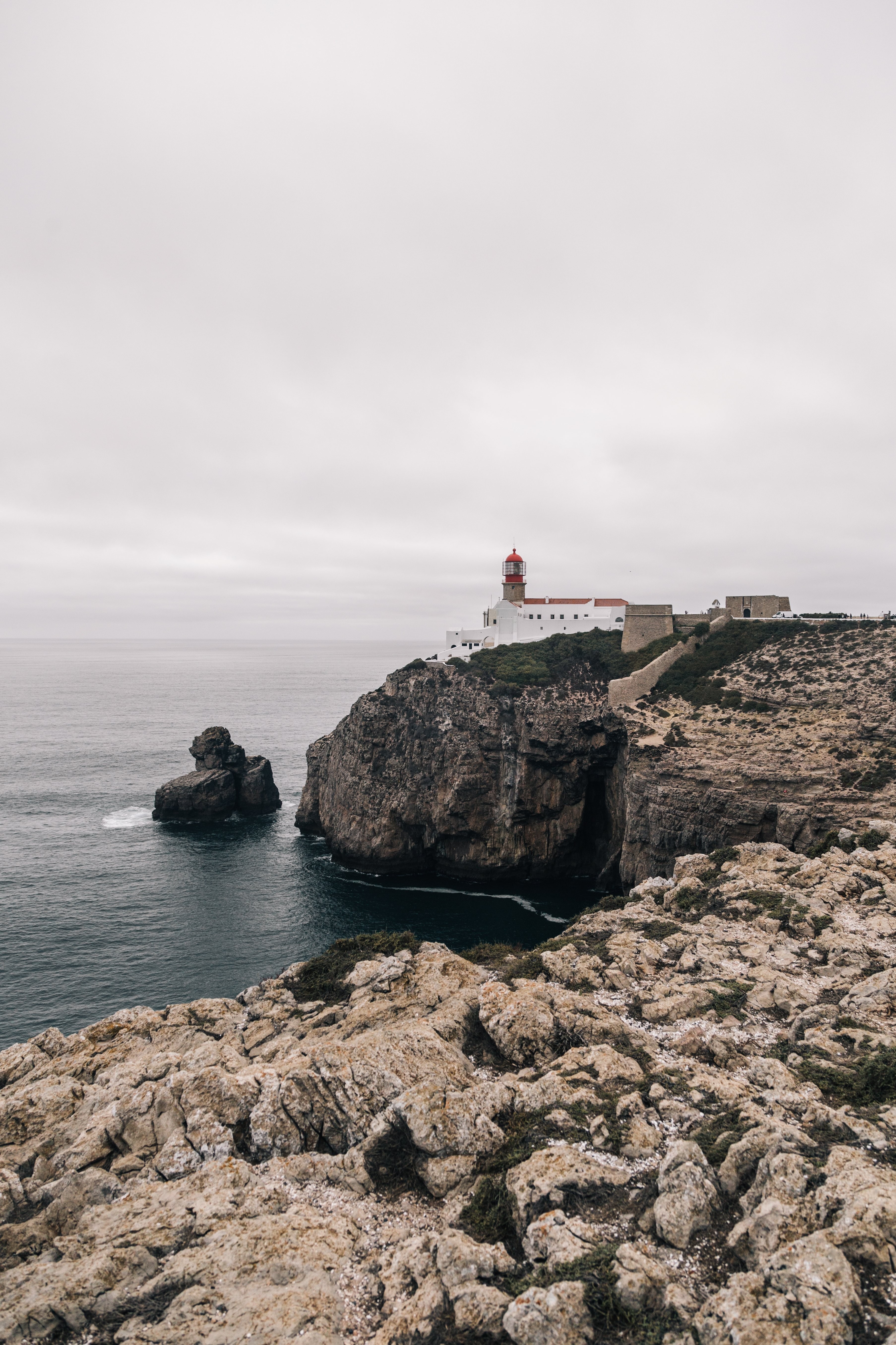 Majestic Lighthouse Over Rocky Coastline – Stunning Coastal Photo
