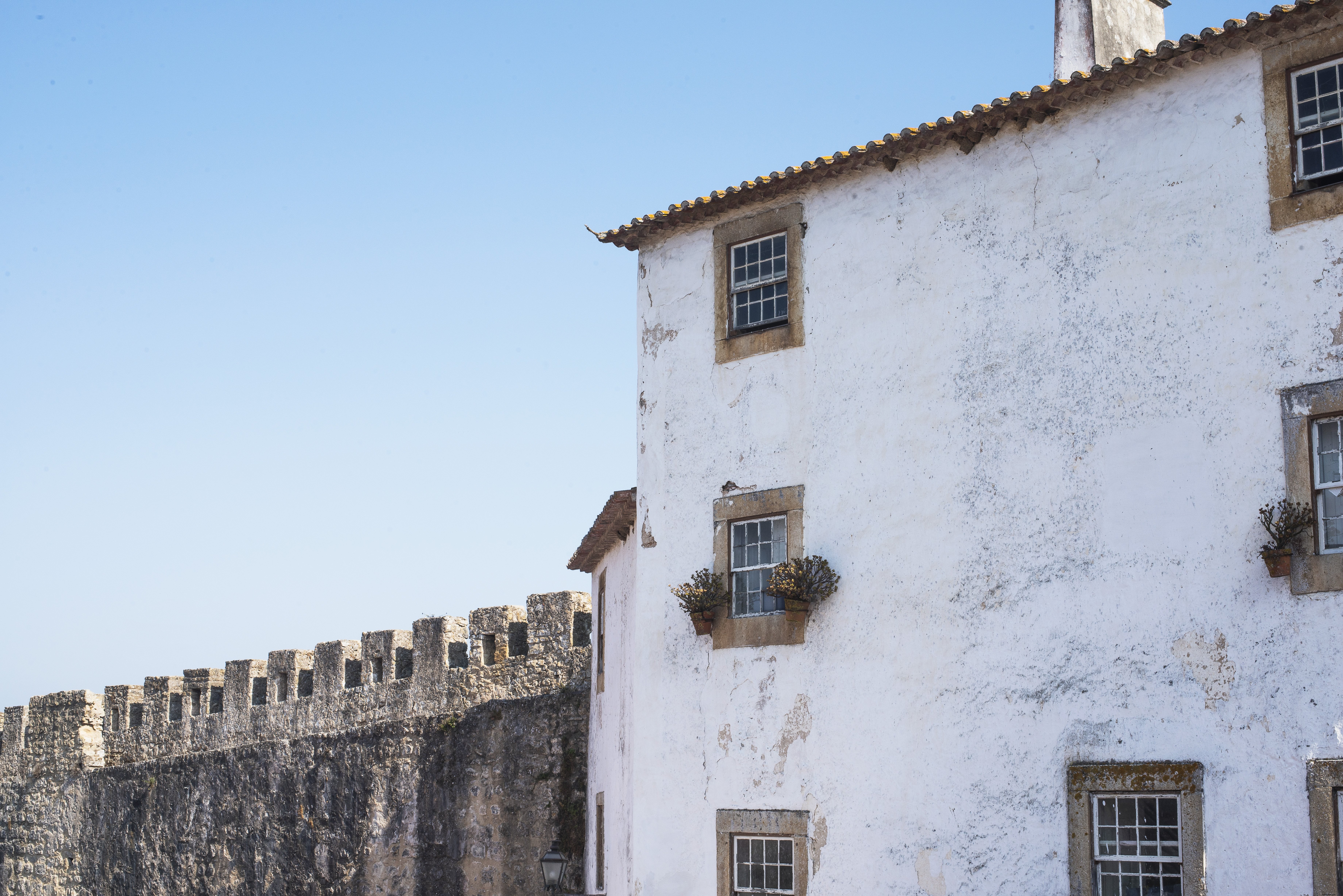 Stunning Photo: Historic Old Town Building Under Clear Blue Sky