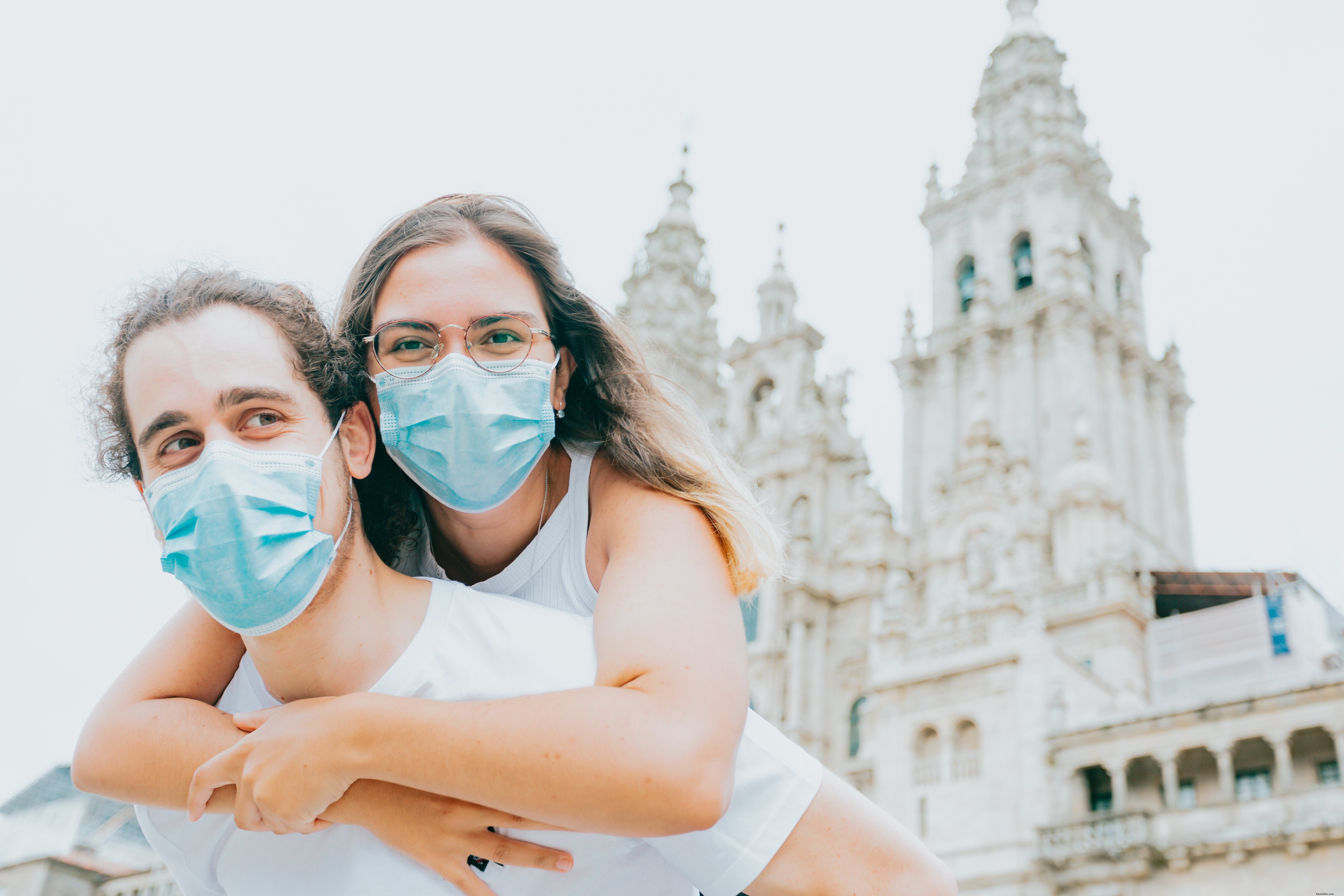 Heartfelt Embrace: Woman in Blue Face Mask Hugs Man – Touching Photo