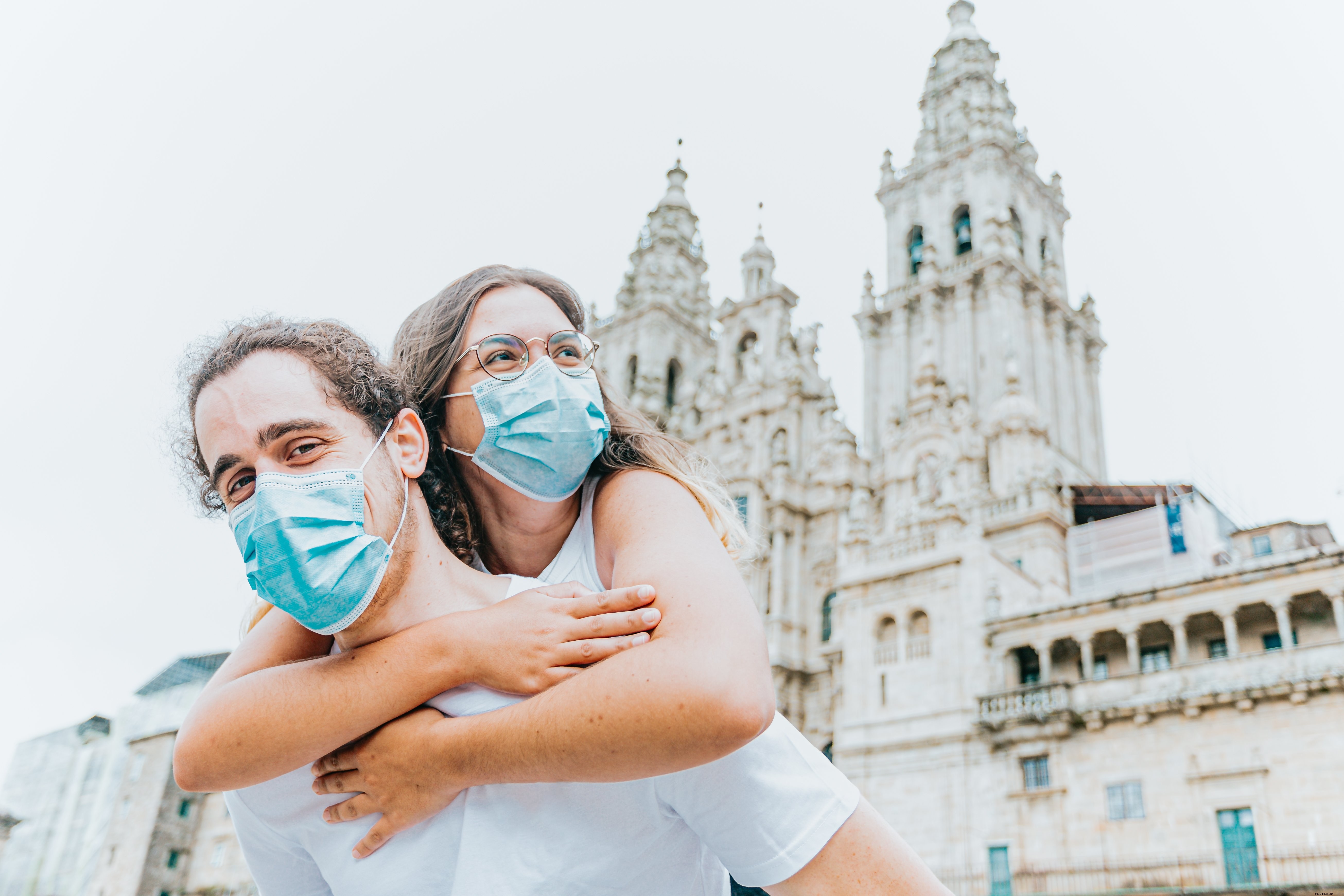 Heartwarming Photo: Woman in Blue Face Mask Hugs Man from Behind