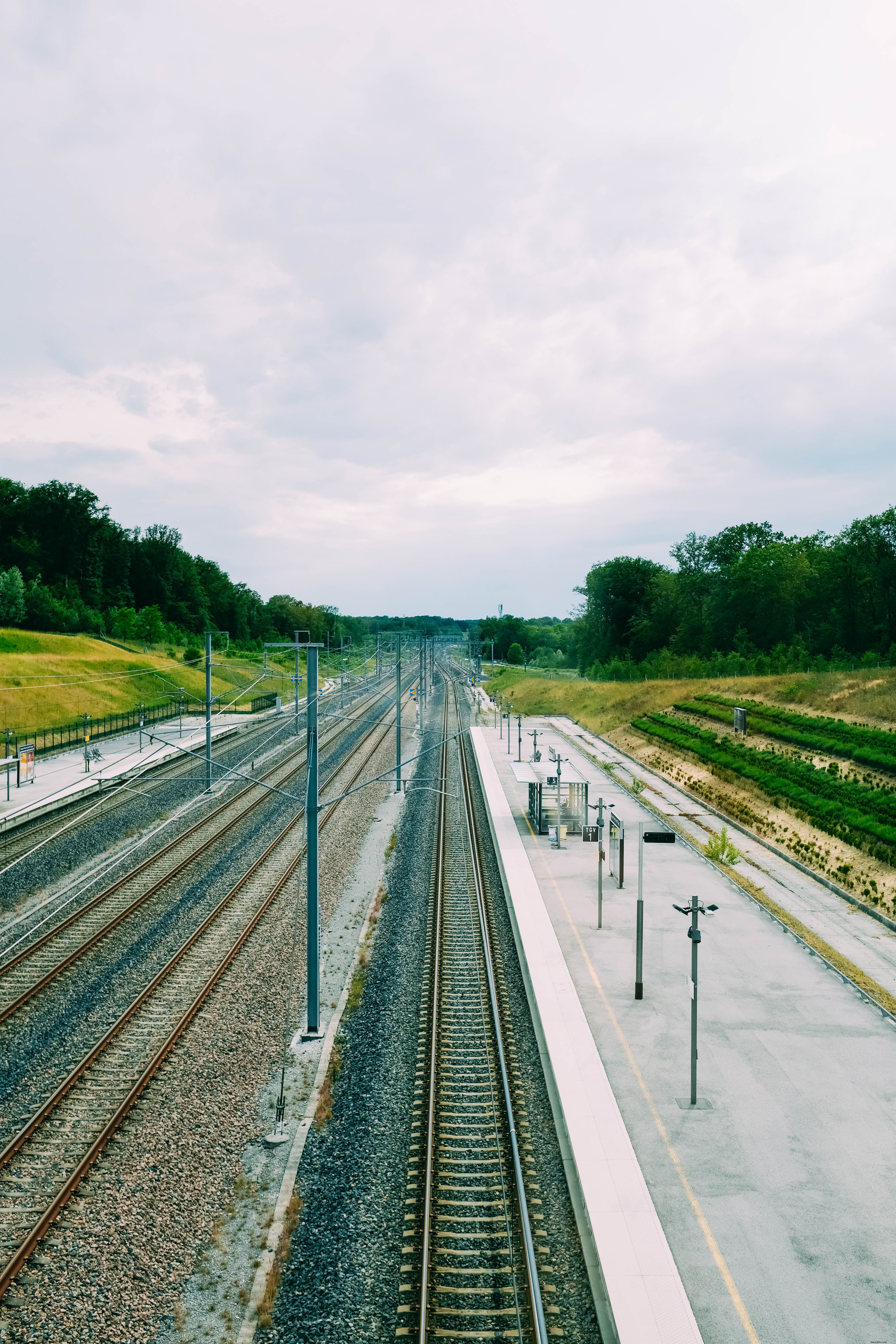 Captivating Photo of Empty Train Tracks Beside a Deserted Platform