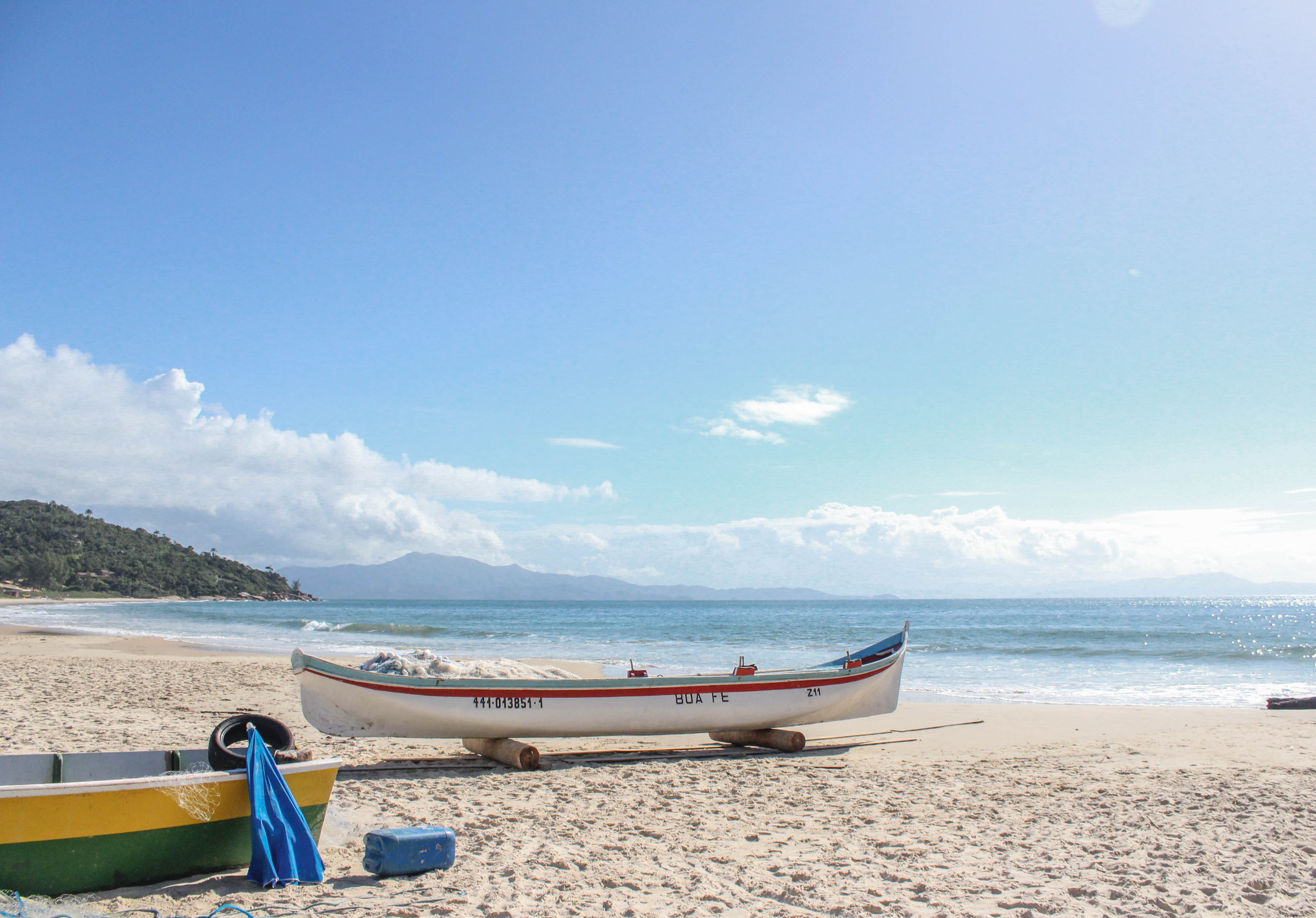 Stunning White Boat with Red Stripe on Pristine Sandy Beach Photo