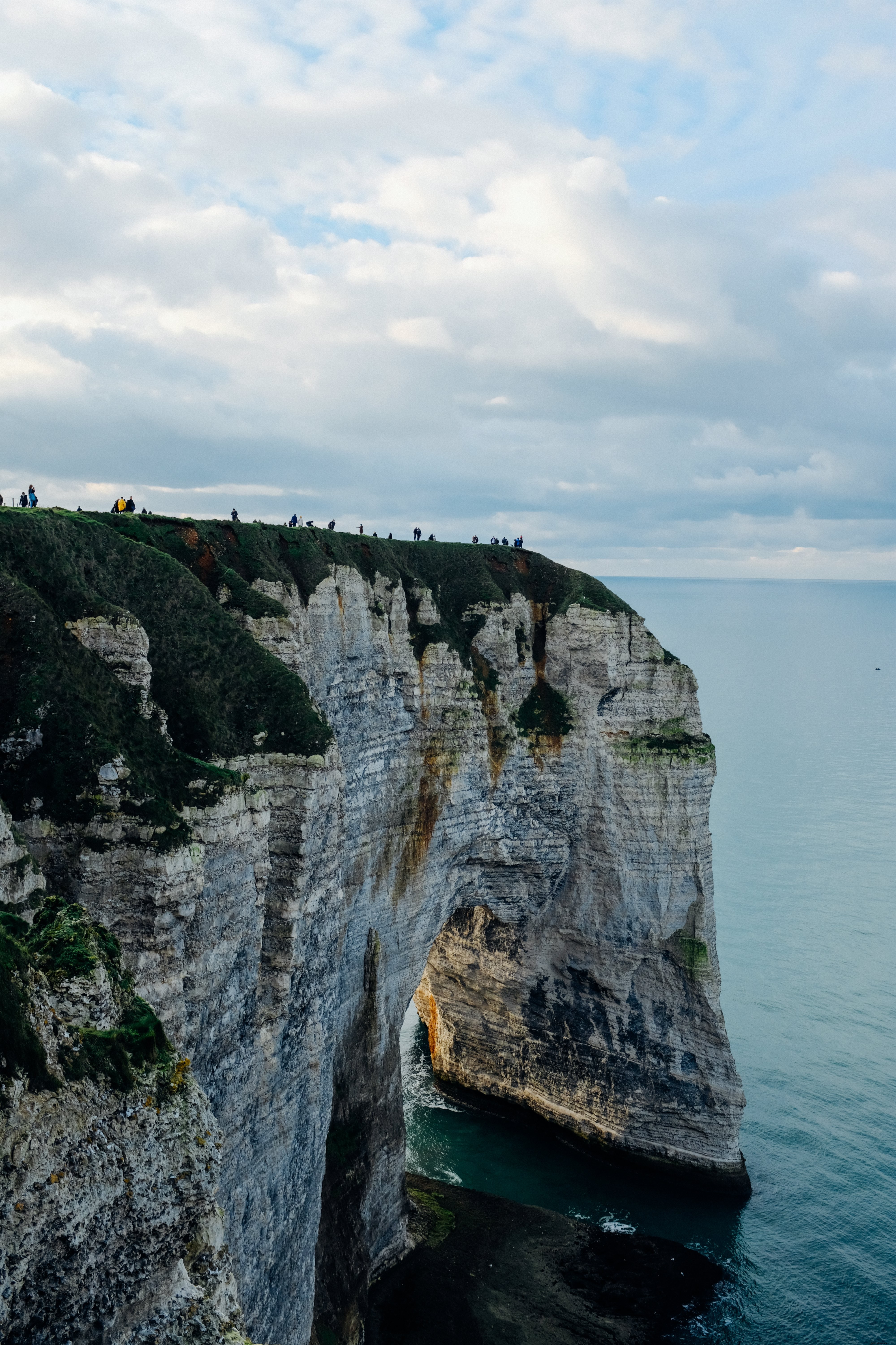 Stunning Grassy-Topped Rock Overlooking the Ocean – Breathtaking Seascape Photo