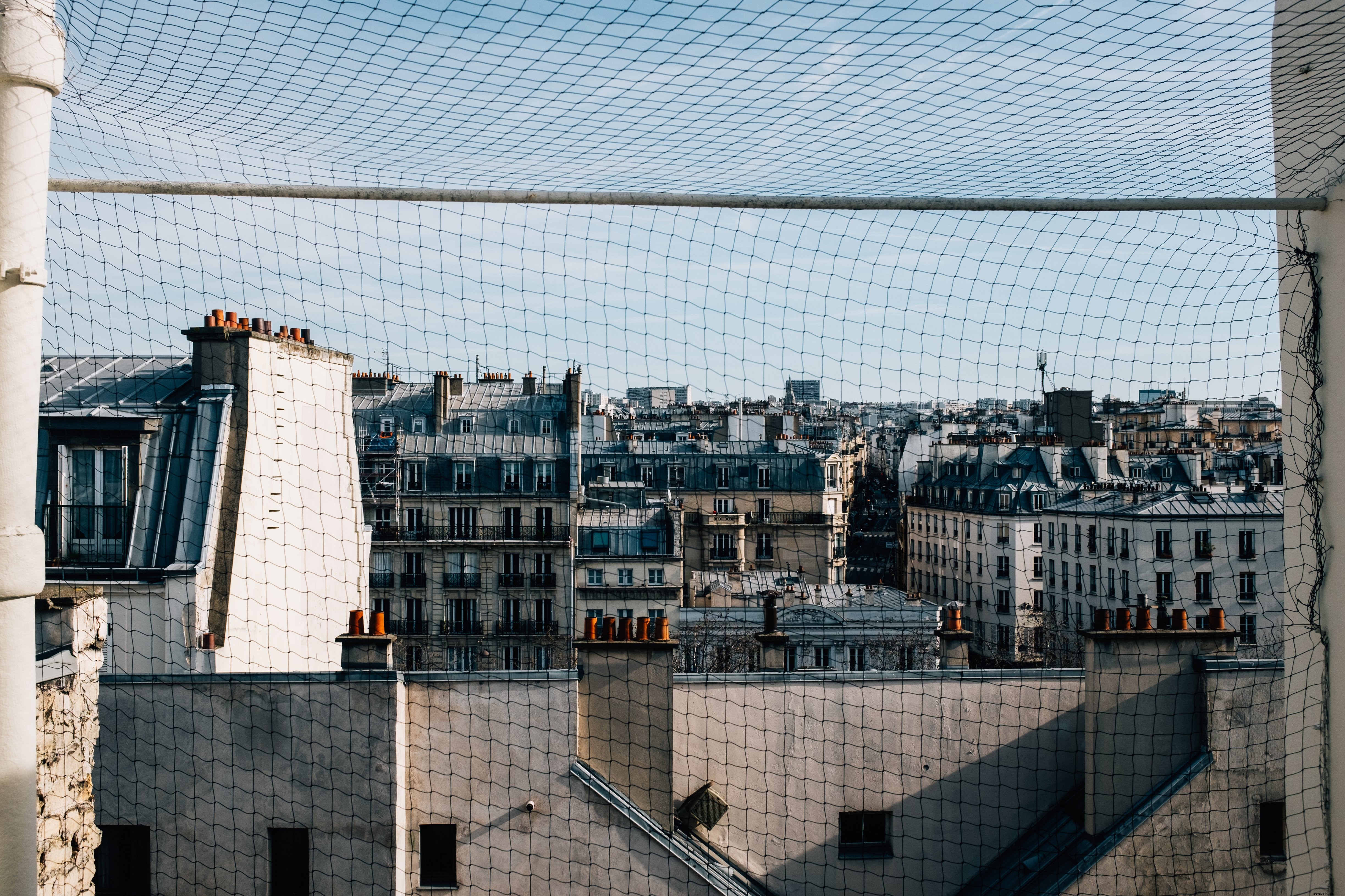 Captivating Photo: White Buildings Framed by Wire Fence