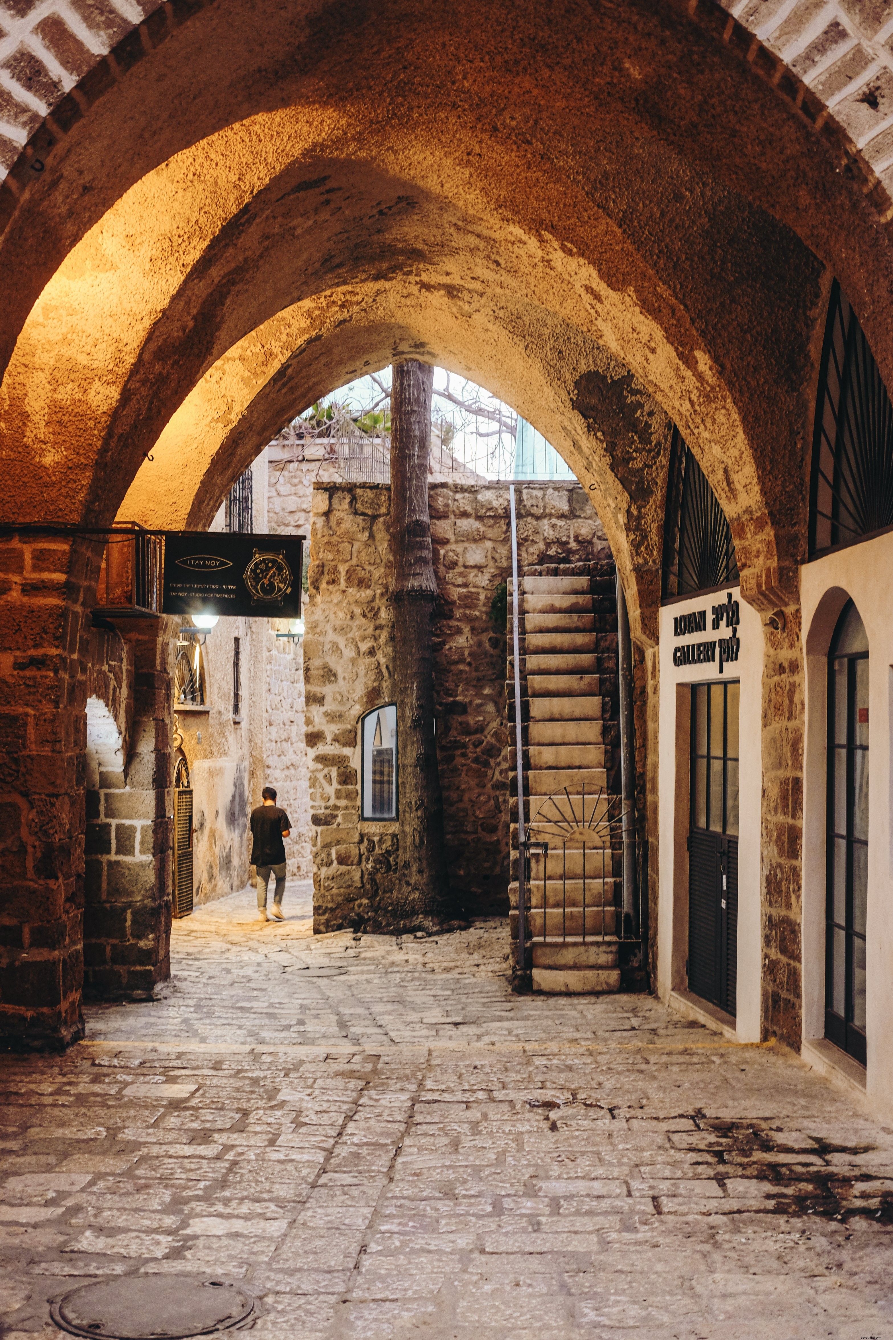 Majestic Stone Archway Framing a Serene Walkway with Distant Figure – Stunning Photo