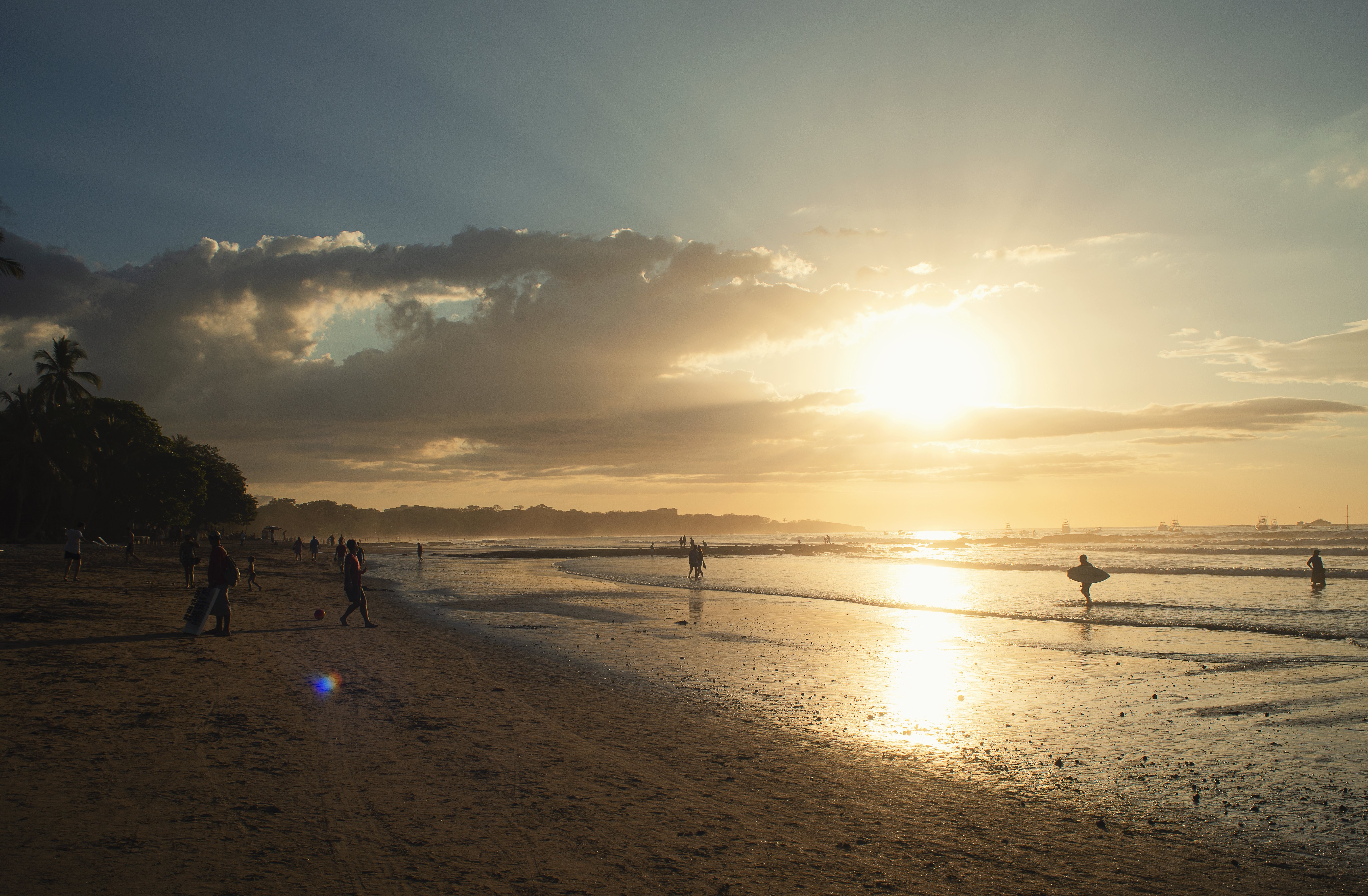 Stunning Sunset Over Distant Waters: Golden Rays on Serene Horizon Photo