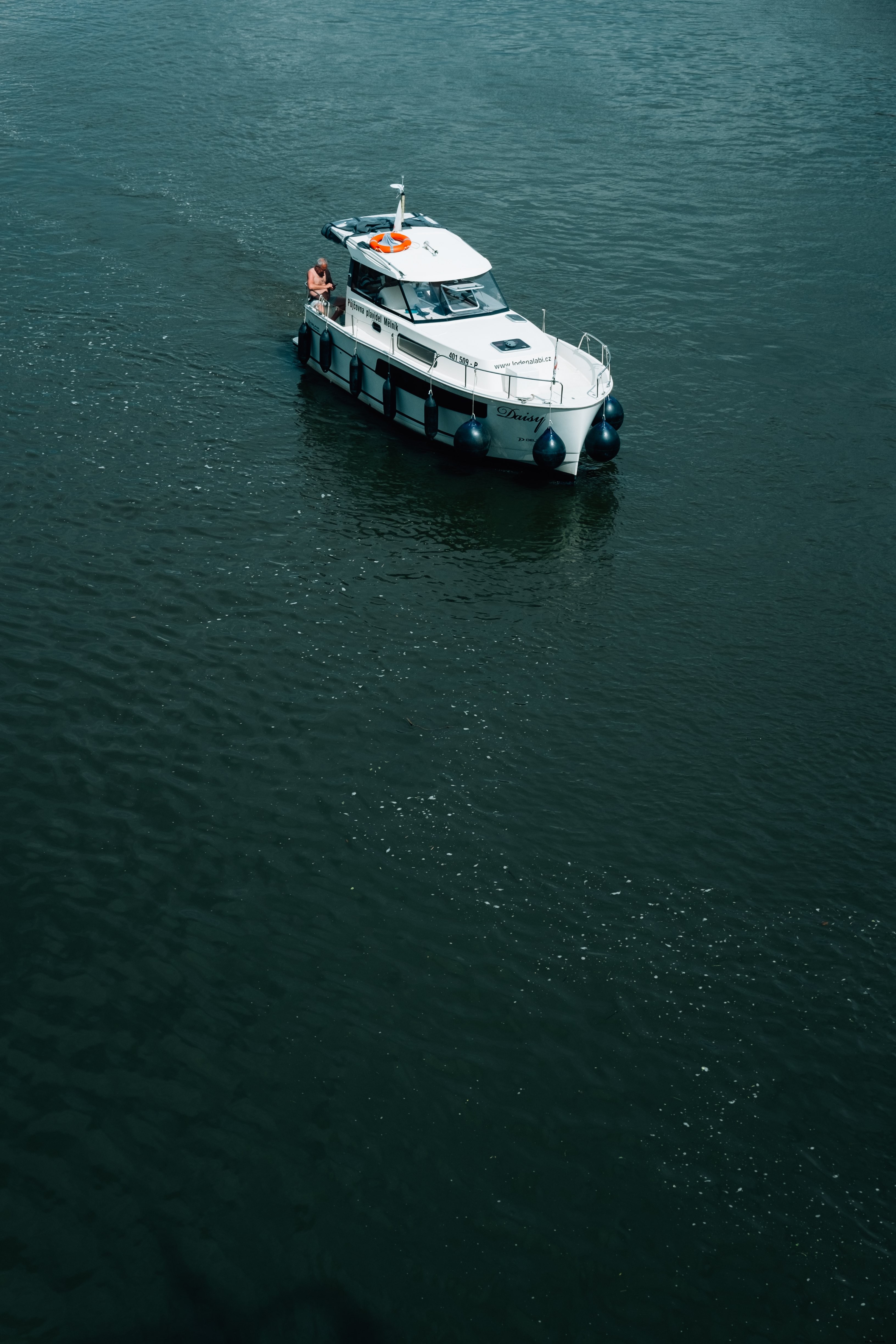 Stunning Photo: White Boat with Person on Deep Blue Waters