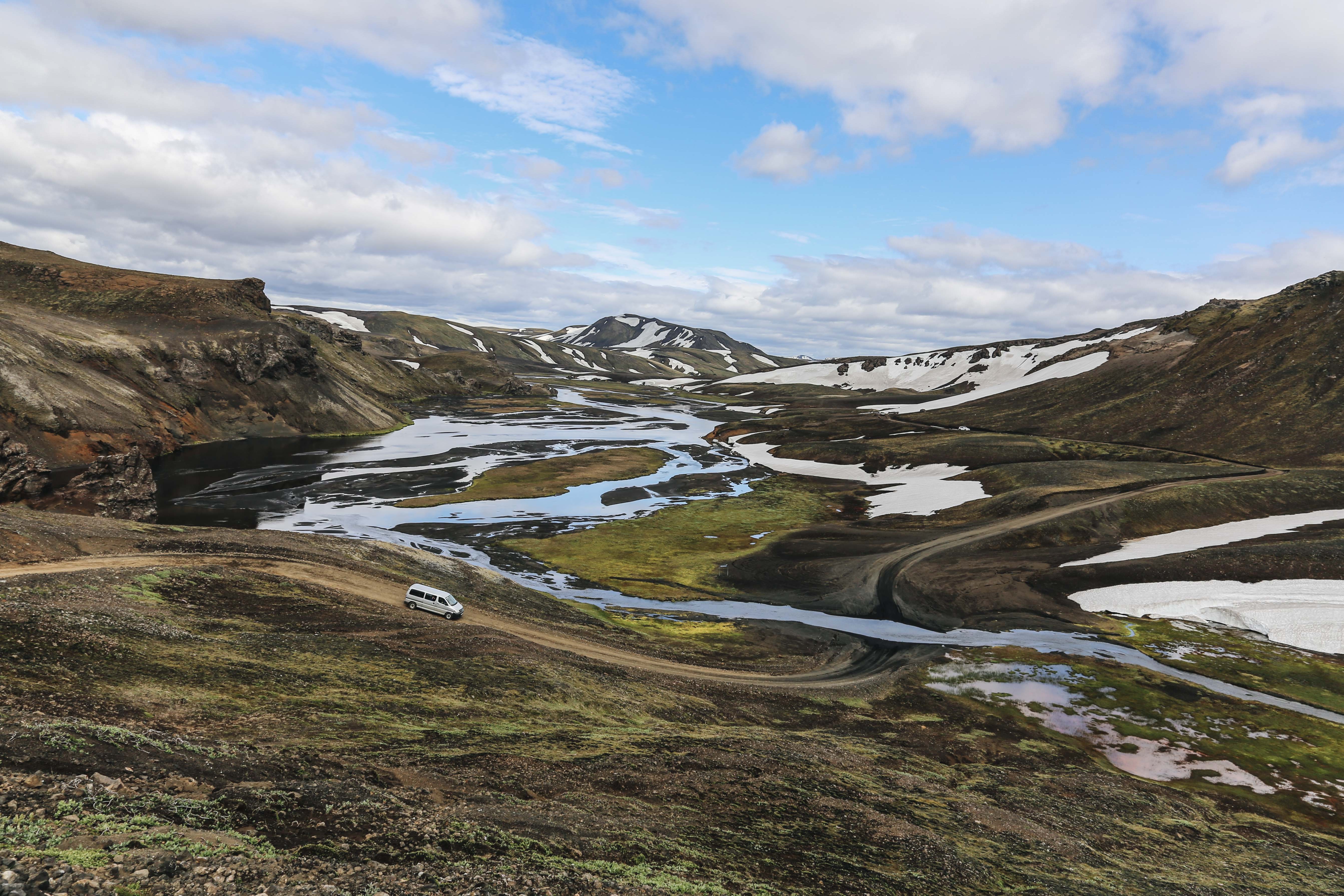 Stunning Photo: White Van Journeying Through Scenic Hills
