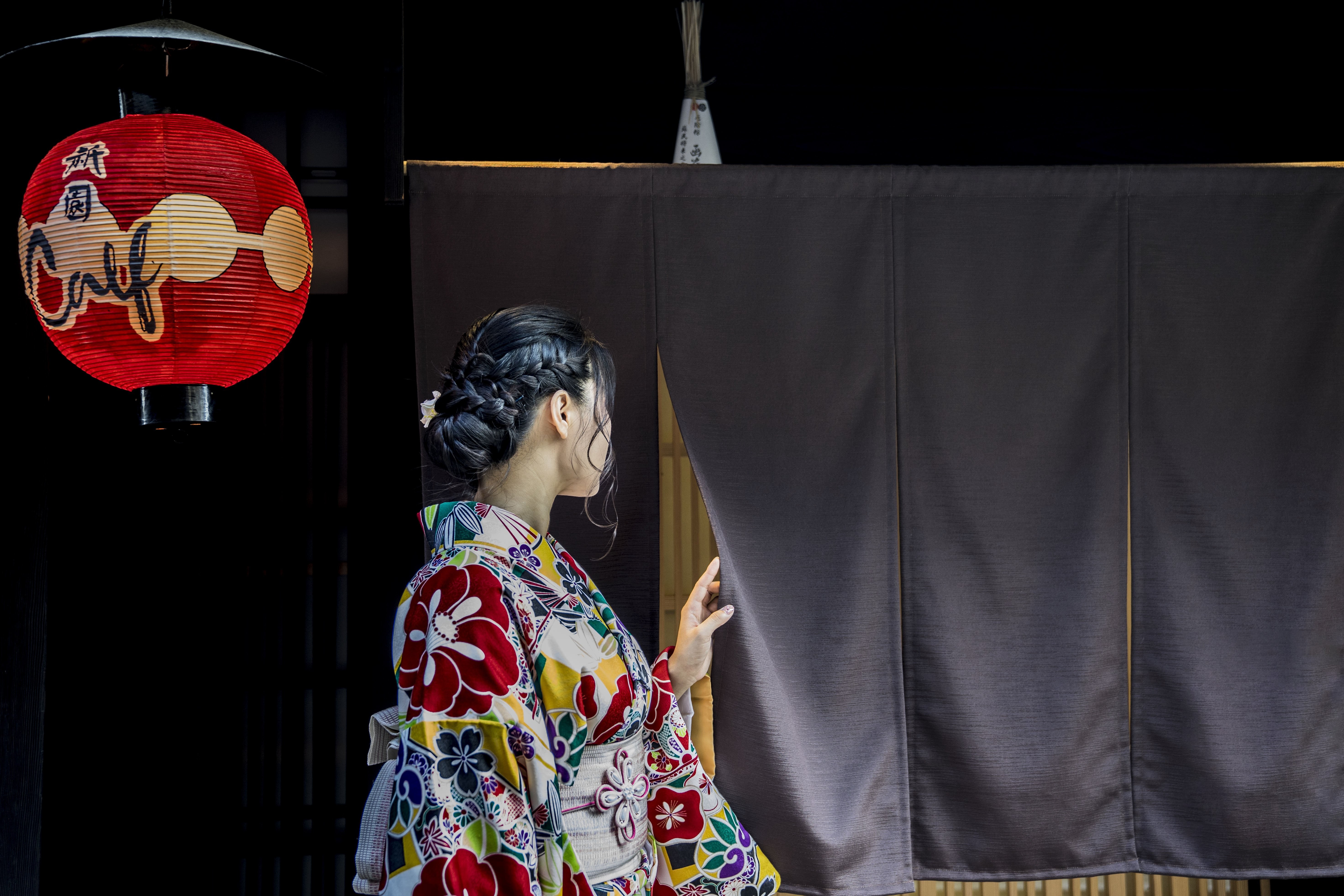 Mysterious Figure in Kimono Peeking Behind Black Curtain – Stunning Photo