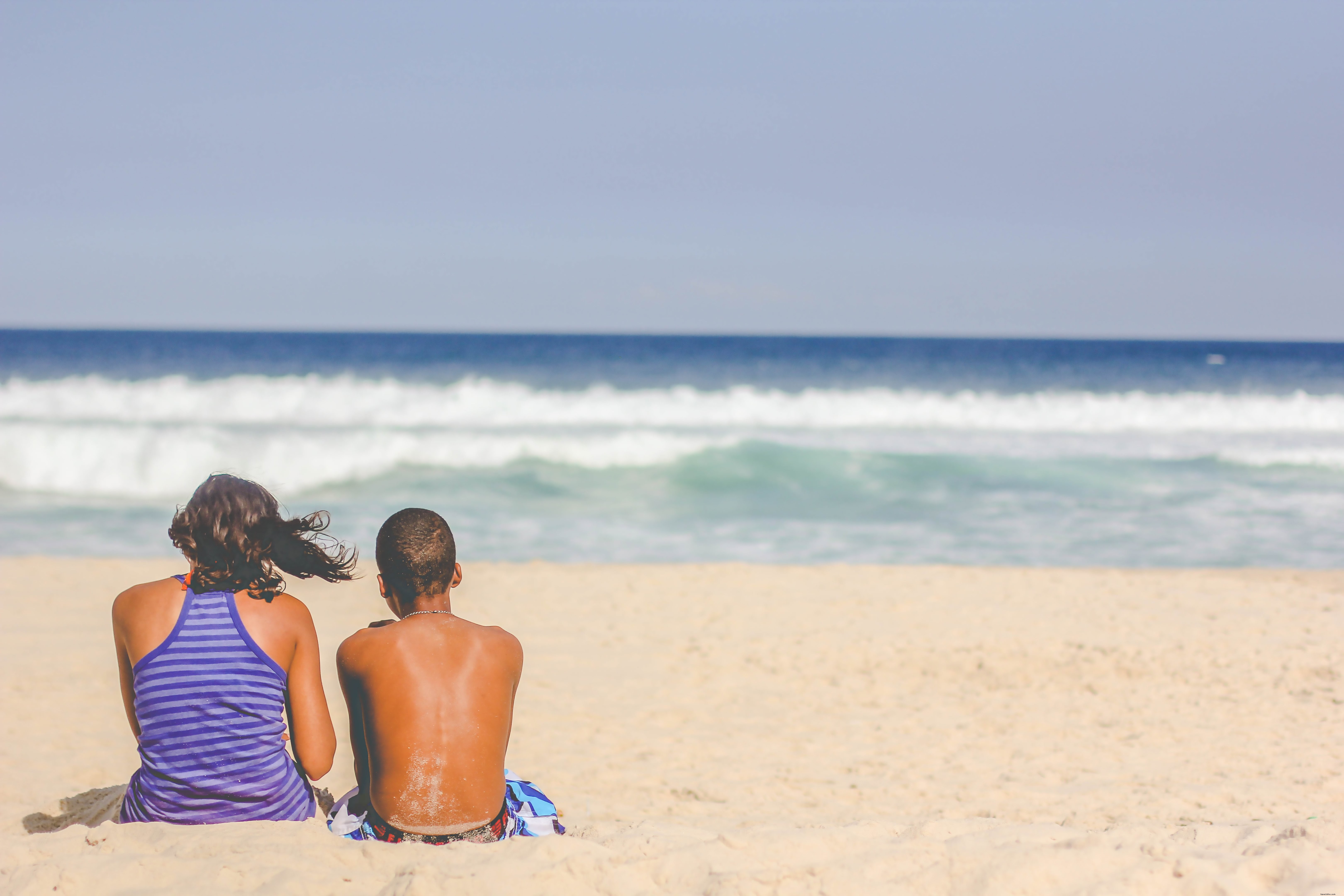 Serene Beach Scene: People Relaxing and Gazing at the Ocean