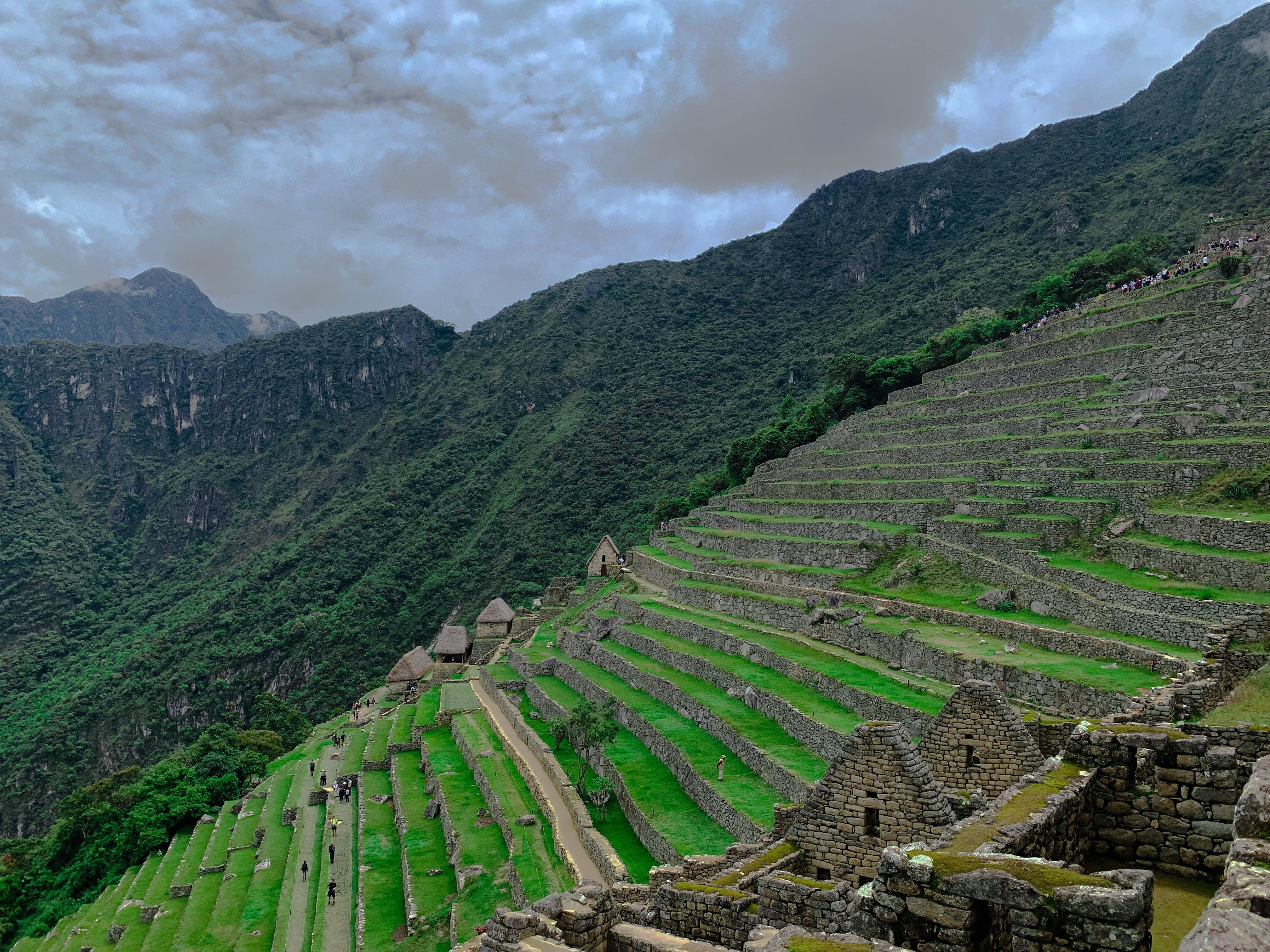 Stunning Photo of Stone Buildings and Steps Beside a Lush Green Hill
