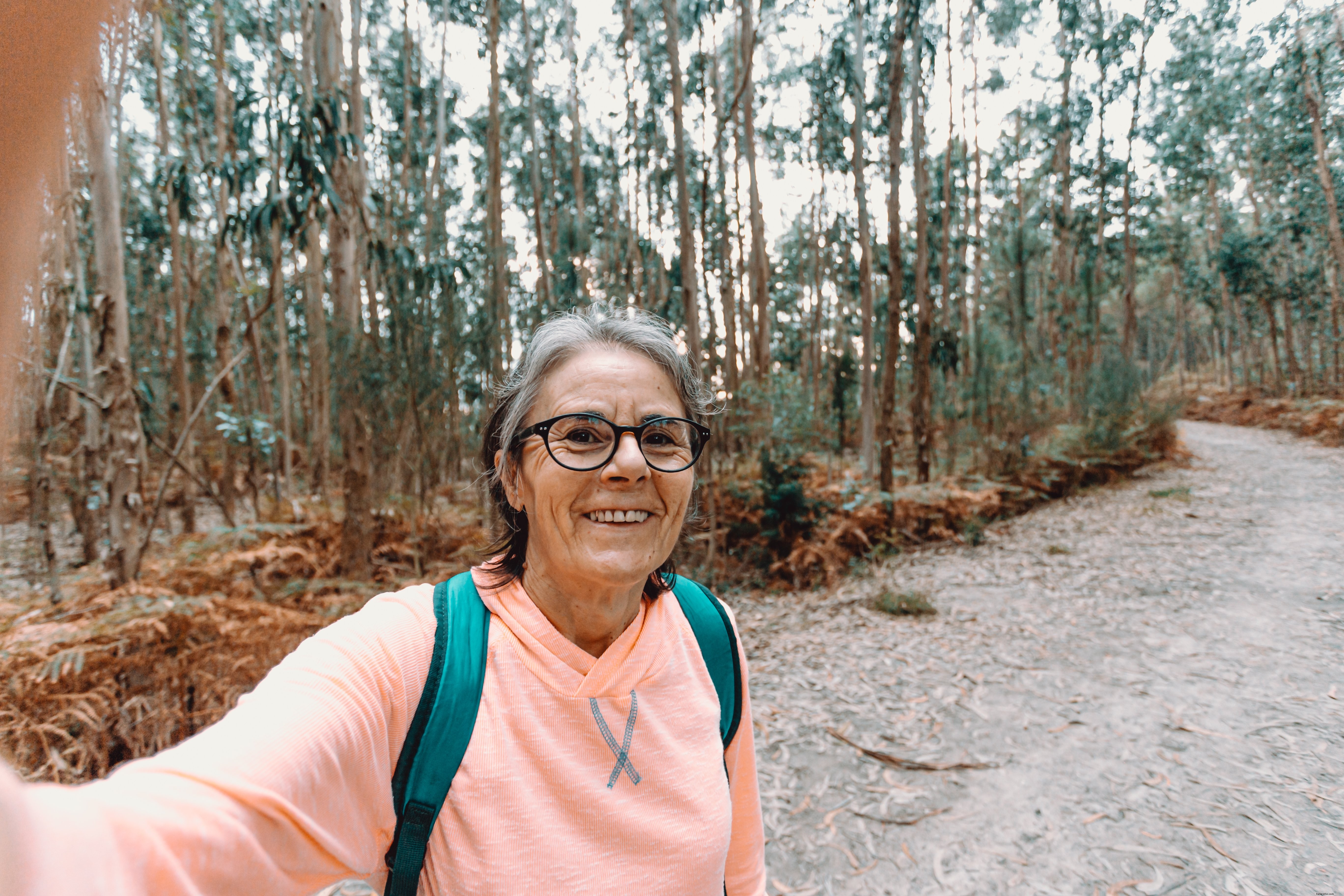 Smiling Woman Captures Joyful Selfie on Scenic Hike – Stunning Outdoor Photo