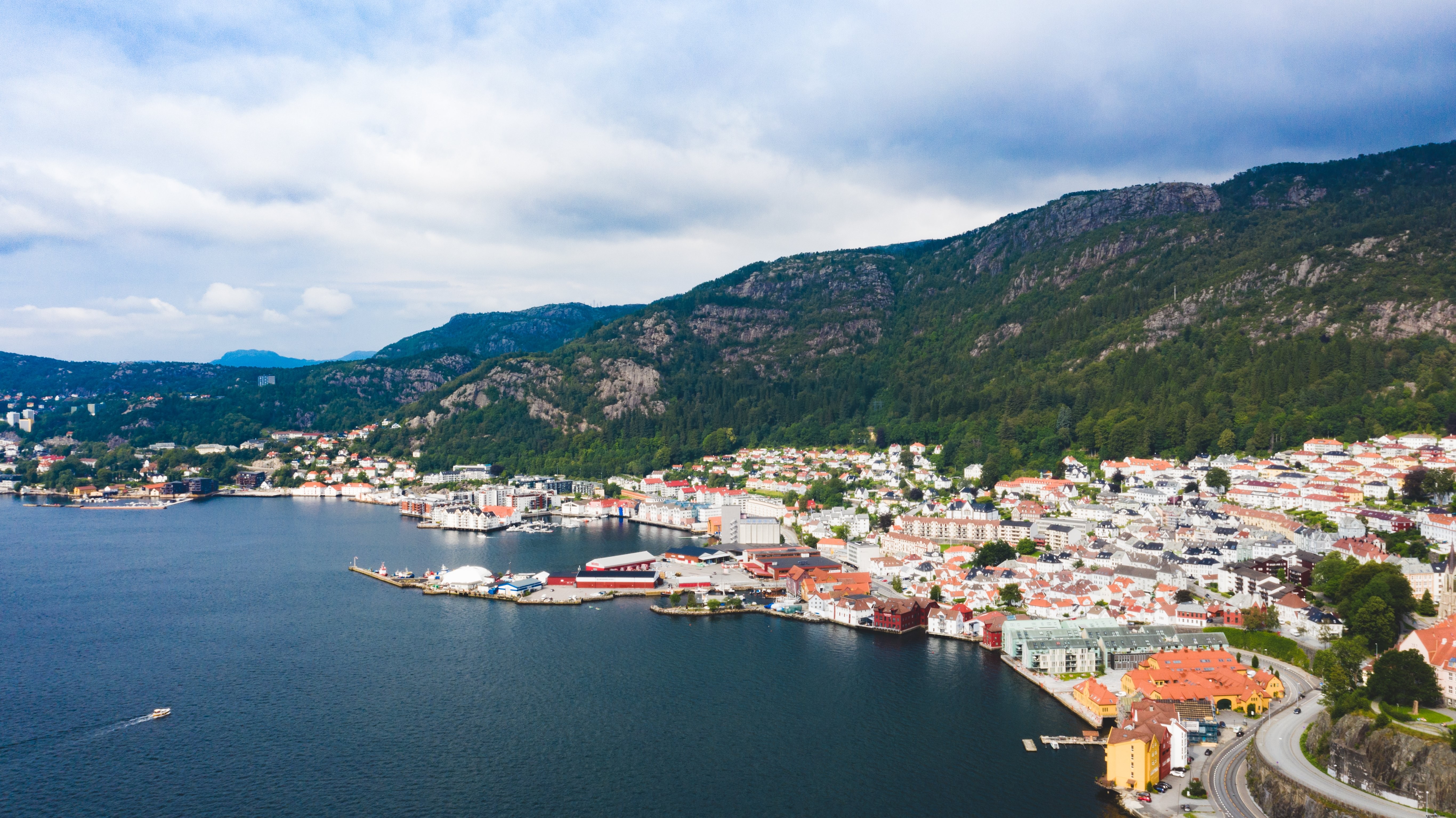 Stunning Photo: Boat Sailing into Picturesque Town Harbor