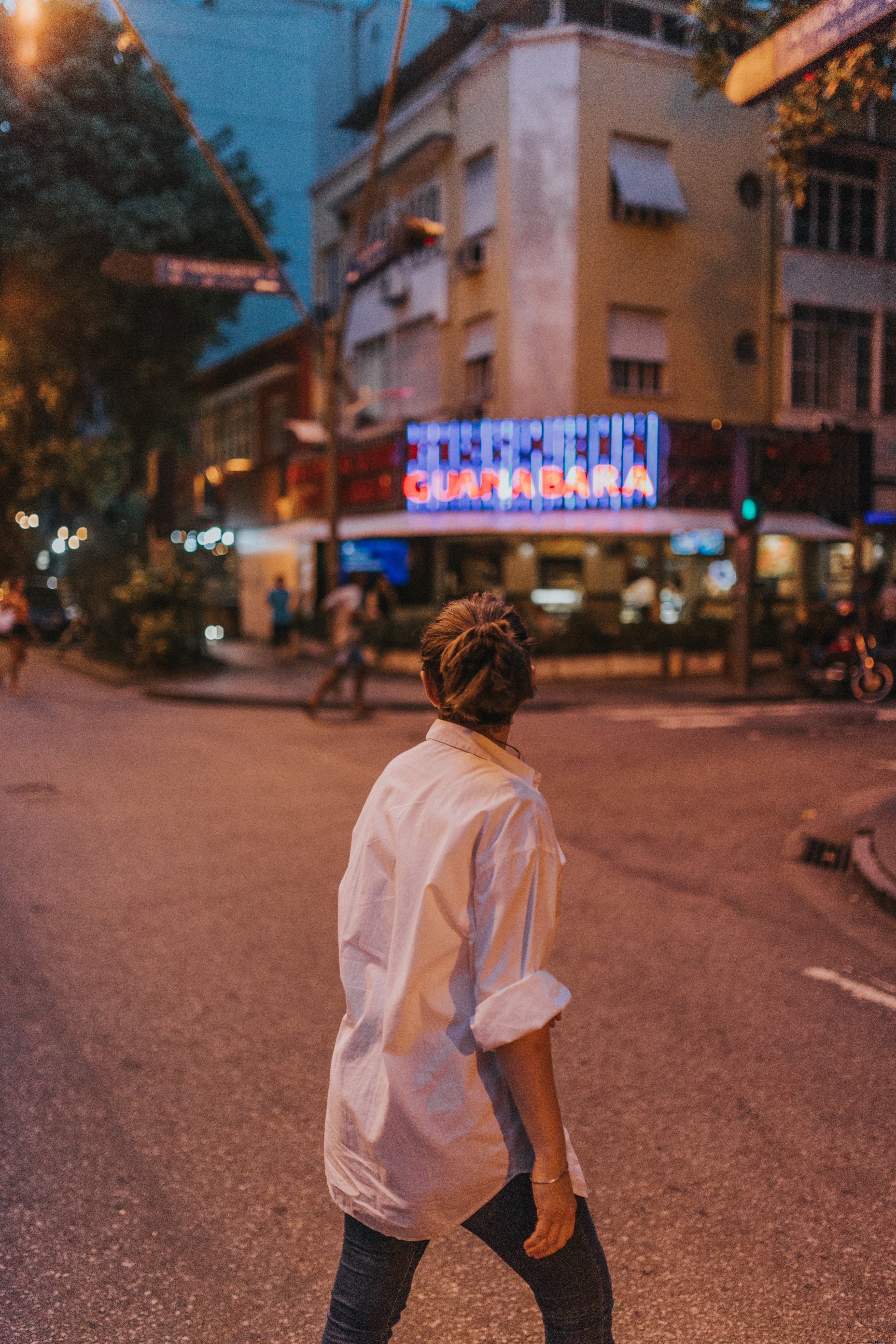 Captivating Street Photo: Person in White Shirt Crossing Urban Road